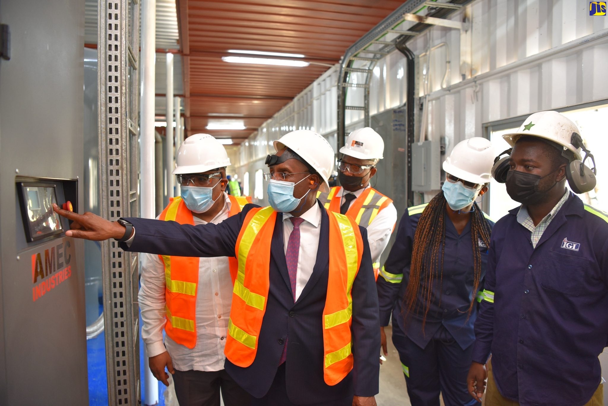 Minister of Industry, Investment and Commerce, Senator the Hon. Aubyn Hill (second left), flicks a switch to officially commission IGL Limited’s new pressure swing absorption (PSA) facility at its plant at Ferry, St. Catherine, into service on Wednesday (March 16). Others (from left) are Leader of Opposition Business in the House of Representatives, Anthony Hylton; and IGL team members – Quality, Health, Safety and Environment Manager, Keith Davis; Engineer, Tami-Leigh Mitchell; and Senior Operations Engineer, Michael Wynter. The facility was developed at a cost of nearly $100 million.
