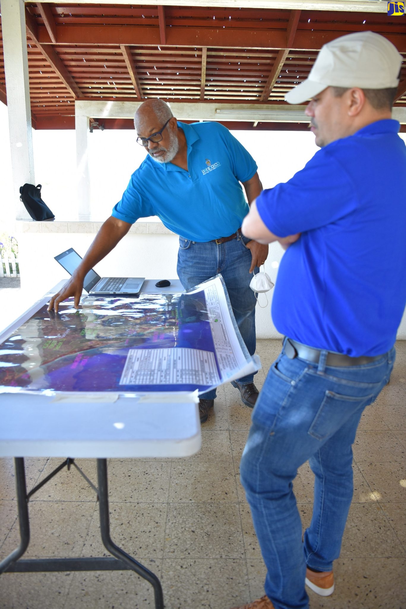 Min. Samuda looks at map showing Mangrove areas in Clarendon while being briefed by Professor Terrence Forrester, Chief Scientist & Managing Director, UWI Solutions for Developing Countries (SODECO).