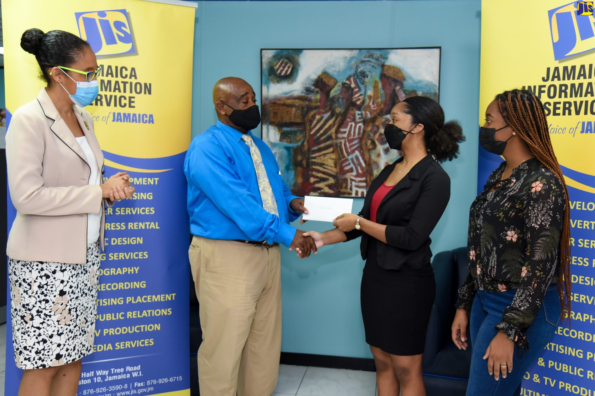Chief Executive Officer of the Jamaica Information Service (JIS), Donna-Marie Rowe (left), looks on as University of the West Indies (UWI) student Katherine Bryan-Rattray (second right) presents the proceeds of a fundraiser to Director of the Mt. Olivet Boys’ Home, Patrick Newman. At right is Nordia Thompson, also of UWI. The students participated in the Applied Group Dynamics course, which raised funds towards the purchase of tablets for the boys at the Home. The facility, located in Walderston, Manchester, was adopted by the JIS in 2009 and remains the agency’s main corporate social responsibility project.