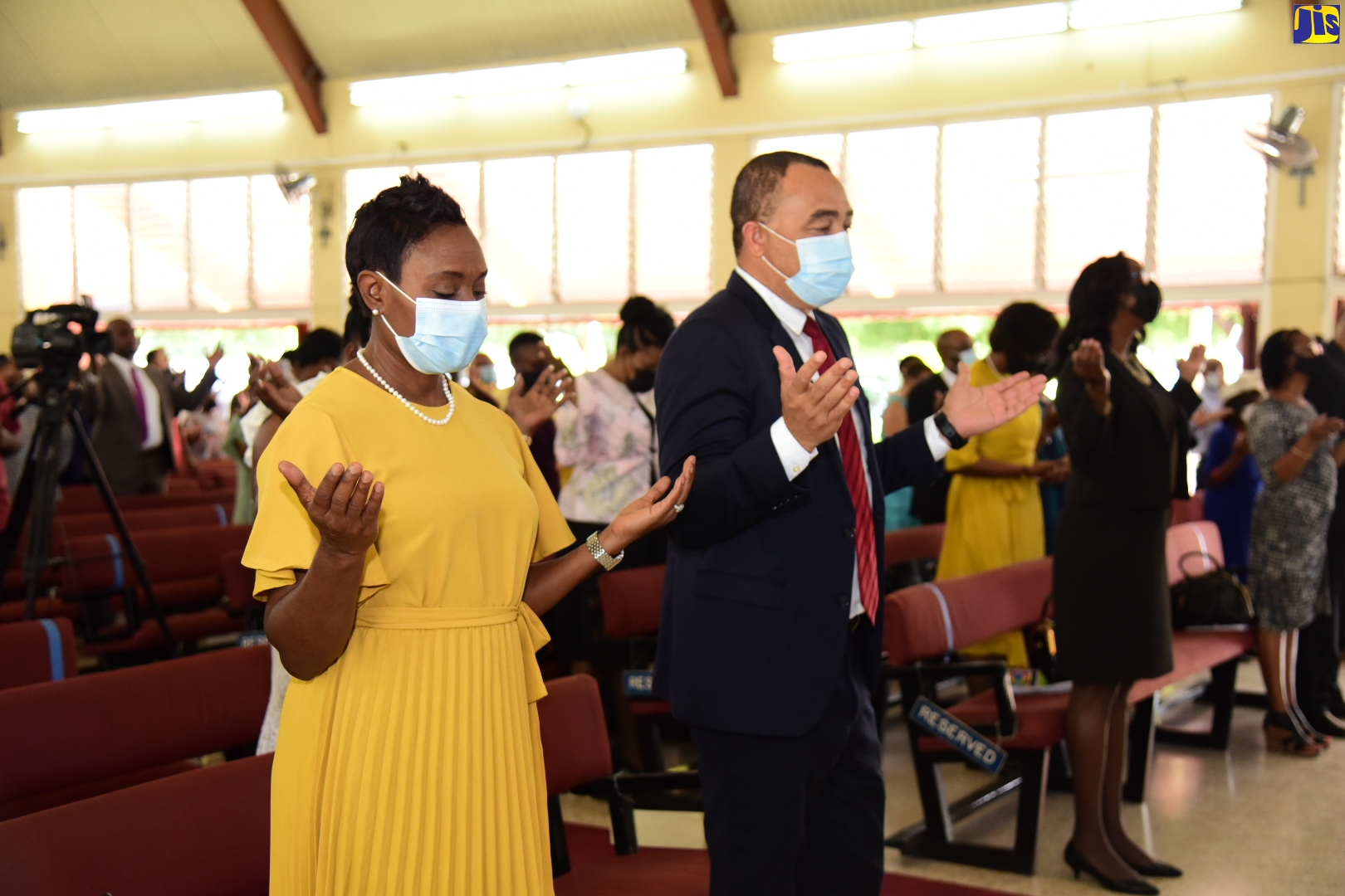 Minister of Health and Wellness, Dr. Hon. Christopher Tufton (second left), and Minister of State in the Ministry, Hon. Juliet Cuthbert Flynn (left), join congregants at Boulevard Baptist Church in St. Andrew, on Sunday (April 3), in praise and worship, during the Ministry’s thanksgiving service to mark the start of the 2022/23 fiscal year. The service was held under the theme ‘Get Back to Life’.