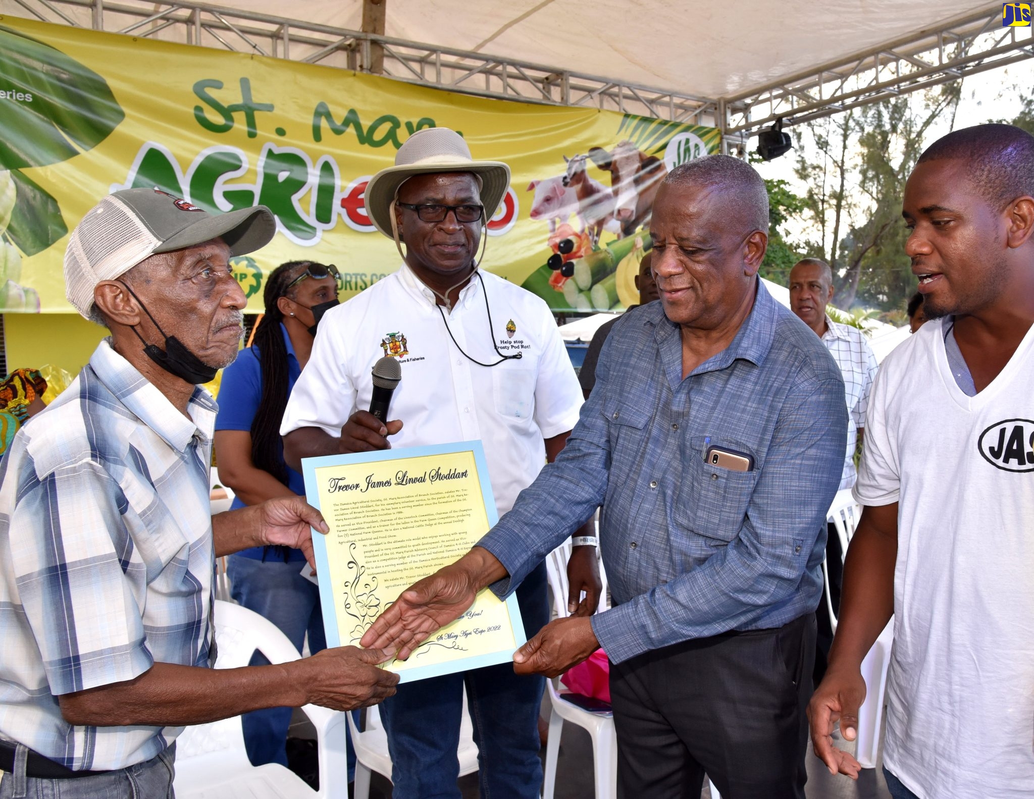 Minister of State in the Ministry of Agriculture and Fisheries, Hon. Franklin Witter (second right), presents educator and community volunteer Trevor Stoddart (left) with an award from the St. Mary Association of Branch Society (ABS) while at the St. Mary Agricultural Show on Monday (April 18), at the Gray’s Inn Sports Complex, Annotto Bay. Others pictured (from left) are Chief Technical Director in the Ministry, Orville Palmer, and President of the ABS, Fabian Rhule.