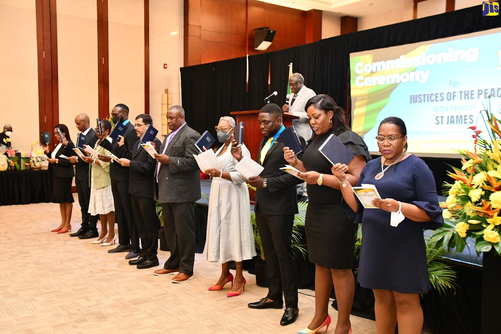 Custos of St. James, Bishop the Hon Conrad Pitkin (background), instructs the newly appointed Justices of the Peace for St. James as they take the Oath of Office during their commissioning ceremony, which was held at the Montego Bay Convention Centre, Rose Hall, in the parish on Thursday (April 21).   