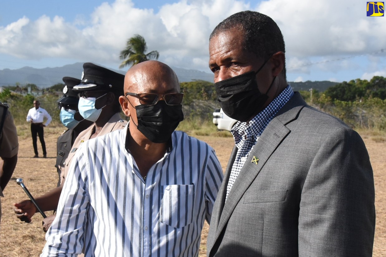 Mayor of Morant Bay, Councillor Michael Hue (left), and Chairman of the Factories Corporation of Jamaica (FCJ), Lyttleton Shirley, in discussion at the recent Factories Corporation of Jamaica (FCJ) Town Hall meeting, held at the old Goodyear Factory, Morant Bay, St. Thomas. It was held to sensitise community members of the activities that will take place during the construction of the Morant Bay Urban Centre. Construction of the Centre is to commence shortly.