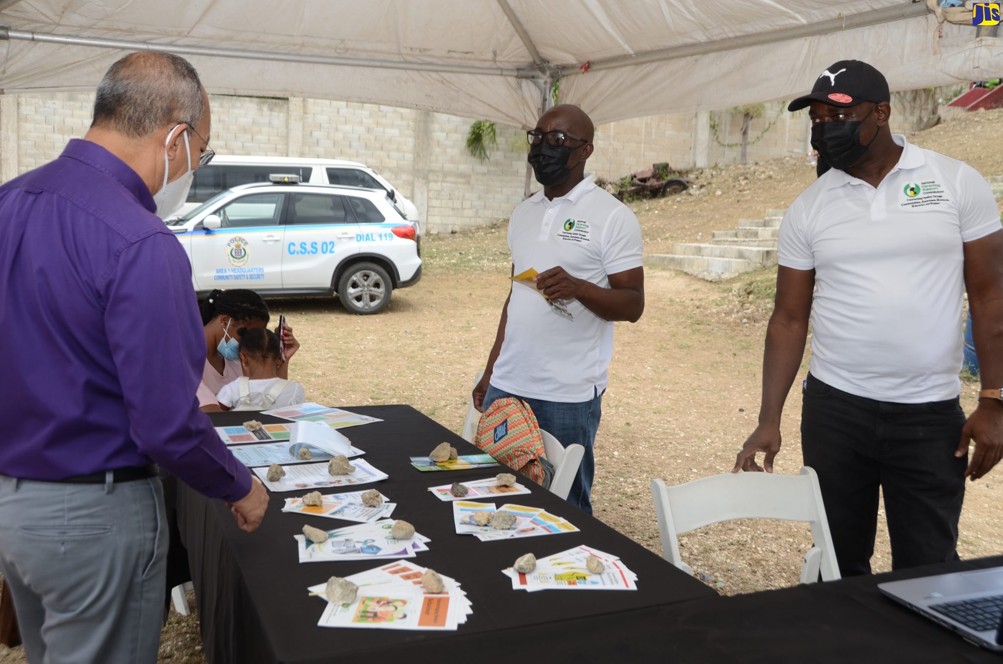 Minister of National Security, Hon. Dr. Horace Chang (left), in discussion with Director of Corporate Services at the National Parenting Support Commission (NPSC),  Garland McDonald (centre), and Manager at the NPSC , Richard Skyers,  at the Commission’s booth, at the Ministry’s inaugural ‘Together We Serve You’ Social Services Fair, which was held at the St. James High School,  recently.