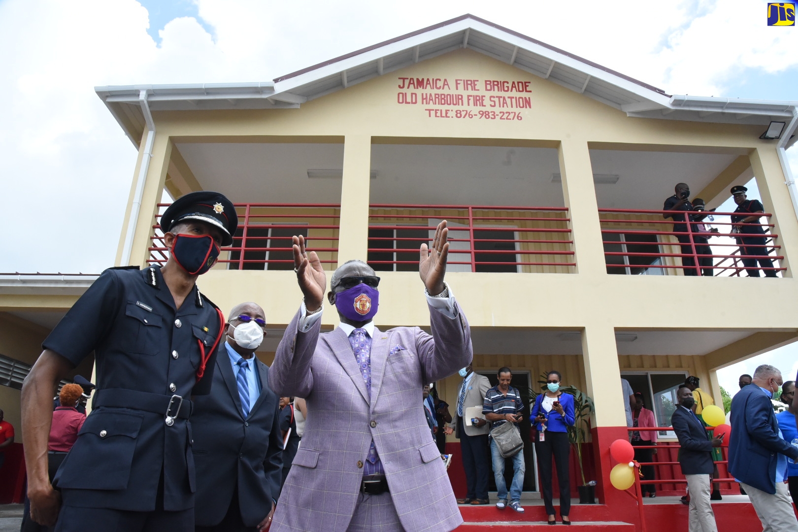 Minister of Local Government and Rural Development, Hon. Desmond McKenzie  (right), gesticulates while conversing with Commissioner, Jamaica Fire Brigade, Stewart Beckford (left), following the official opening of the Old Harbour Fire Station in St. Catherine, on Tuesday (April 19). At centre is Vice Chairman, Jamaica Fire Brigade, Dr. Keith Amiel.