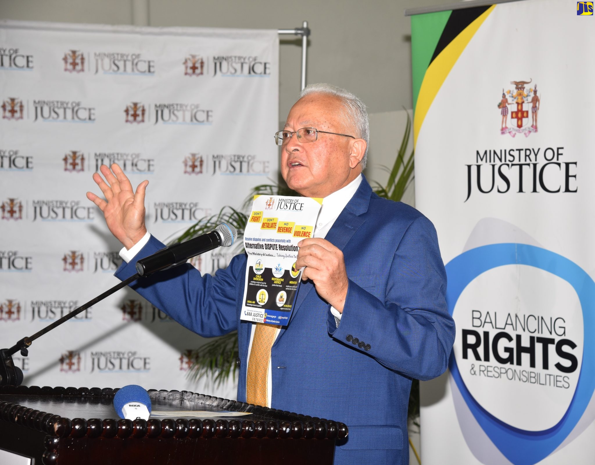 Justice Minister, Hon. Delroy Chuck, displays a flyer for the Ministry’s Alternative Dispute Resolution (ADR) programme. He was addressing the opening of the Greenwich Town Restorative Justice Centre, on Friday (April 8), at the Greenwich Town Resource Centre, St. Andrew, on Friday (April 8).