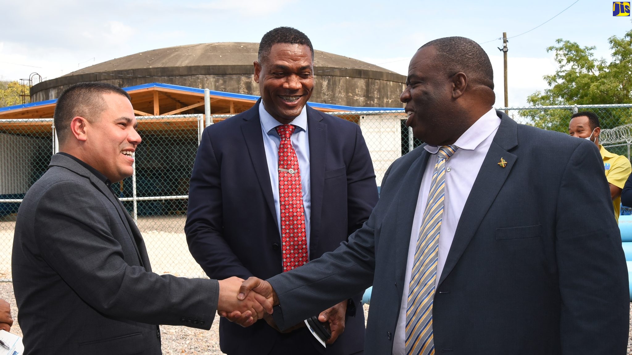 Minister without Portfolio in the Ministry of Economic Growth and Job Creation, Senator the Hon. Matthew Samuda (left), is greeted by Chairman of the National Water Commission (NWC), Michael Shaw (right),  when he arrived at the Miya Water Jamaica office in Portmore, St. Catherine, on Thursday (April 21) to attend a staff recognition ceremony for the teams involved in the Portmore Non-Revenue Water (NRW) Reduction Programme. Looking on is President of the NWC, Mark Barnett.