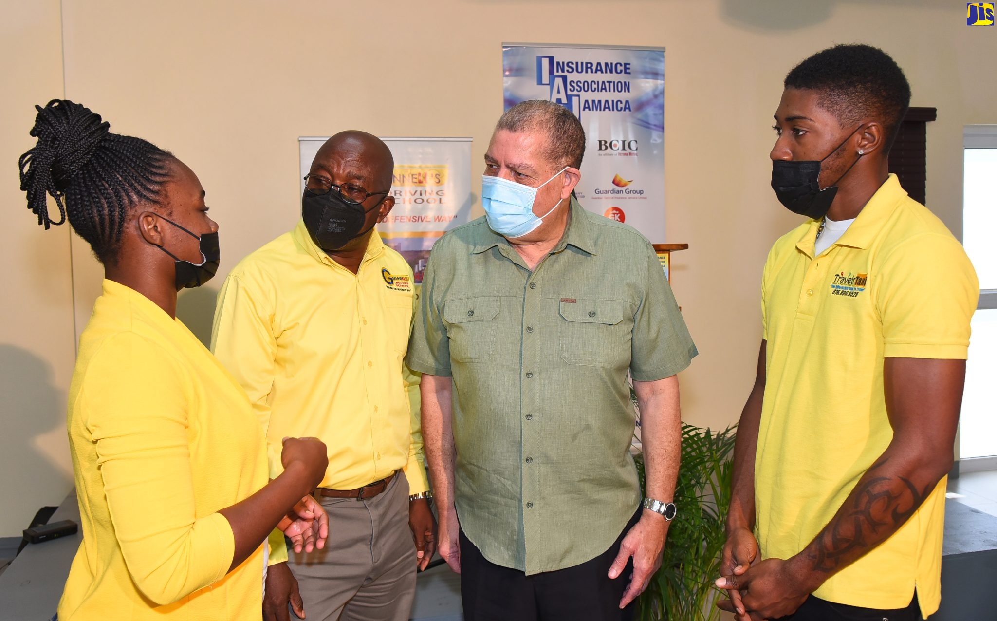 Minister of Transport and Mining, Hon. Audley Shaw (second right), speaks with a participant in the second Taxi Driver Defensive Driving Seminar, Shanae Locke (left), today (April 20),  at the offices  of  Grennell’s Driving School, Portmore Town Centre, St. Catherine. Listening are Managing Director, Grennell’s Driving School, Alphonso Grennell (second left) and participant, Levaughn Powell. The seminar was the second in a series of four slated to be held annually. The first seminar was held in December 2021.