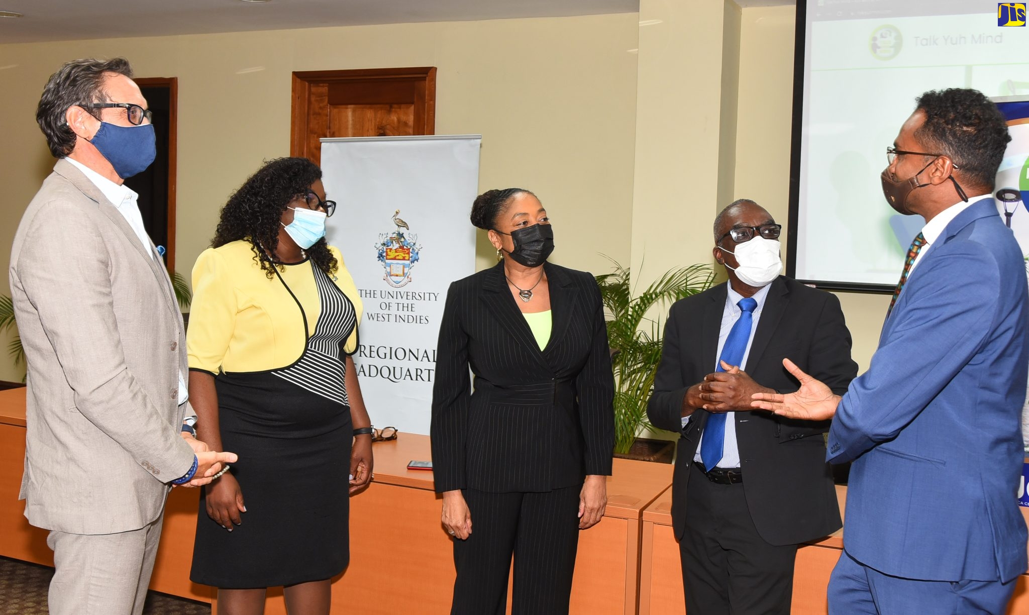 Tourism Enhancement Fund (TEF) Executive Director, Dr. Carey Wallace (right), in discussion with stakeholders participating in Wednesday’s (April 13) launch of the ‘Talk Yuh Mind’ tourism workers counselling support programme at the University of the West Indies (UWI) regional headquarters, Mona, St. Andrew. From left are Chairman, Tourism Linkages Health and Wellness Network which spearheads the initiative, Kyle Mais; Executive Director, Tourism Linkages Network, Carolyn McDonald Riley; Clinical Psychologist, Dr. Rose Johnson; and Consultant Psychiatrist and Therapist, Dr. Wendel Abel.