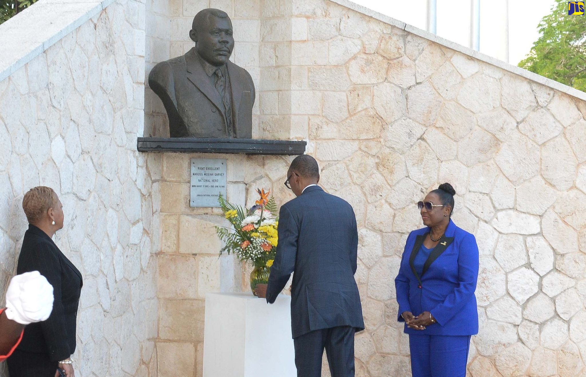 President of the Republic of Rwanda, His Excellency Paul Kagame (centre), lays a floral tribute at the shrine of National Hero, the Rt. Excellent Marcus Garvey, at National Heroes Park, Kingston, today (April 13). Also pictured are Minister of Culture, Gender, Entertainment and Sport, Hon. Olivia Grange (right), and Chief of State Protocol, Ambassador Sandra Grant Griffiths. The President arrived on the island Wednesday for a for a three-day State visit.