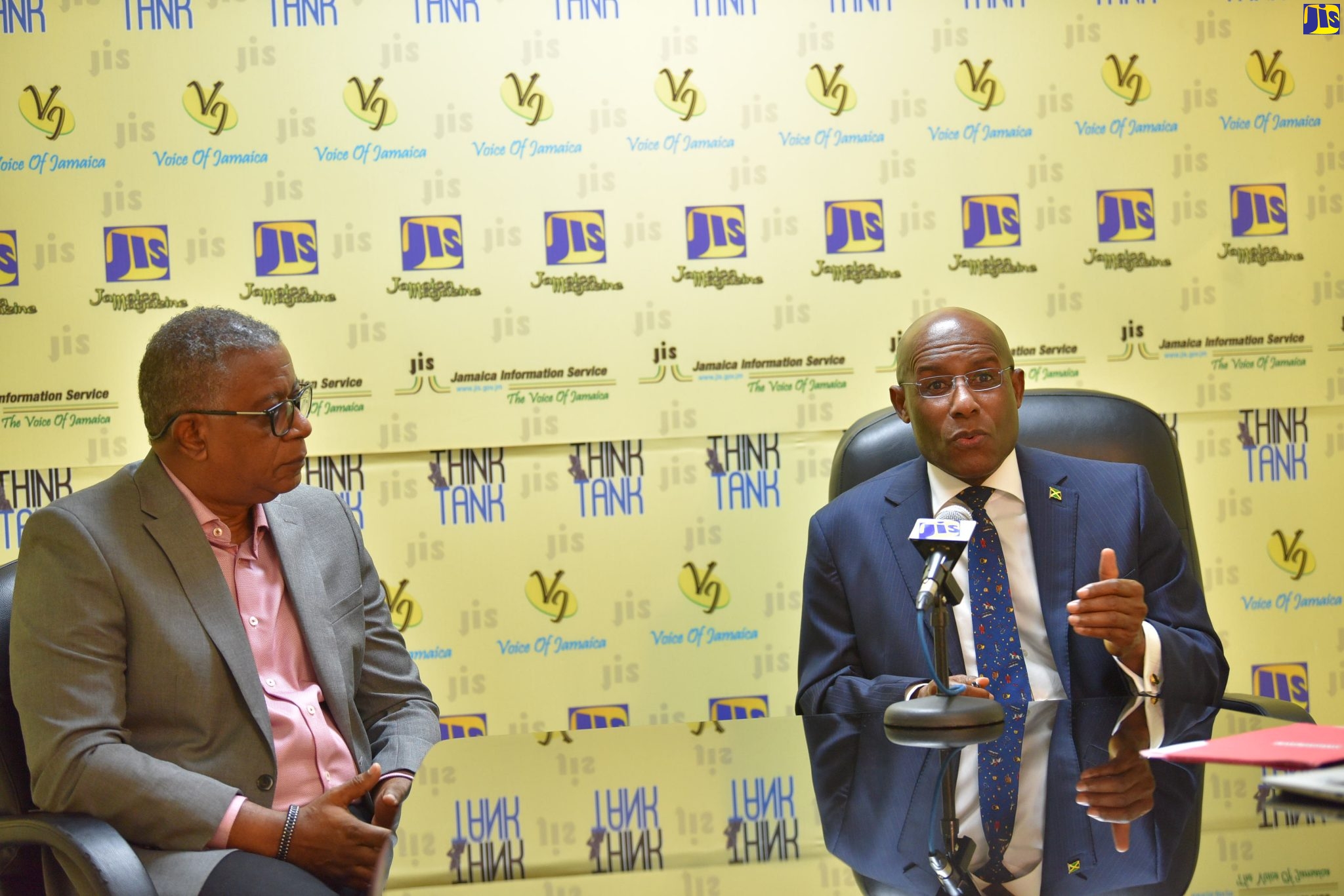 Minister of Industry, Investment and Commerce, Senator the Hon. Aubyn Hill (right), addresses a recent JIS Think Tank, while Acting Chief Executive Officer of the Jamaica Special Economic Zone Authority (JSEZA), Gary Scott, looks on.