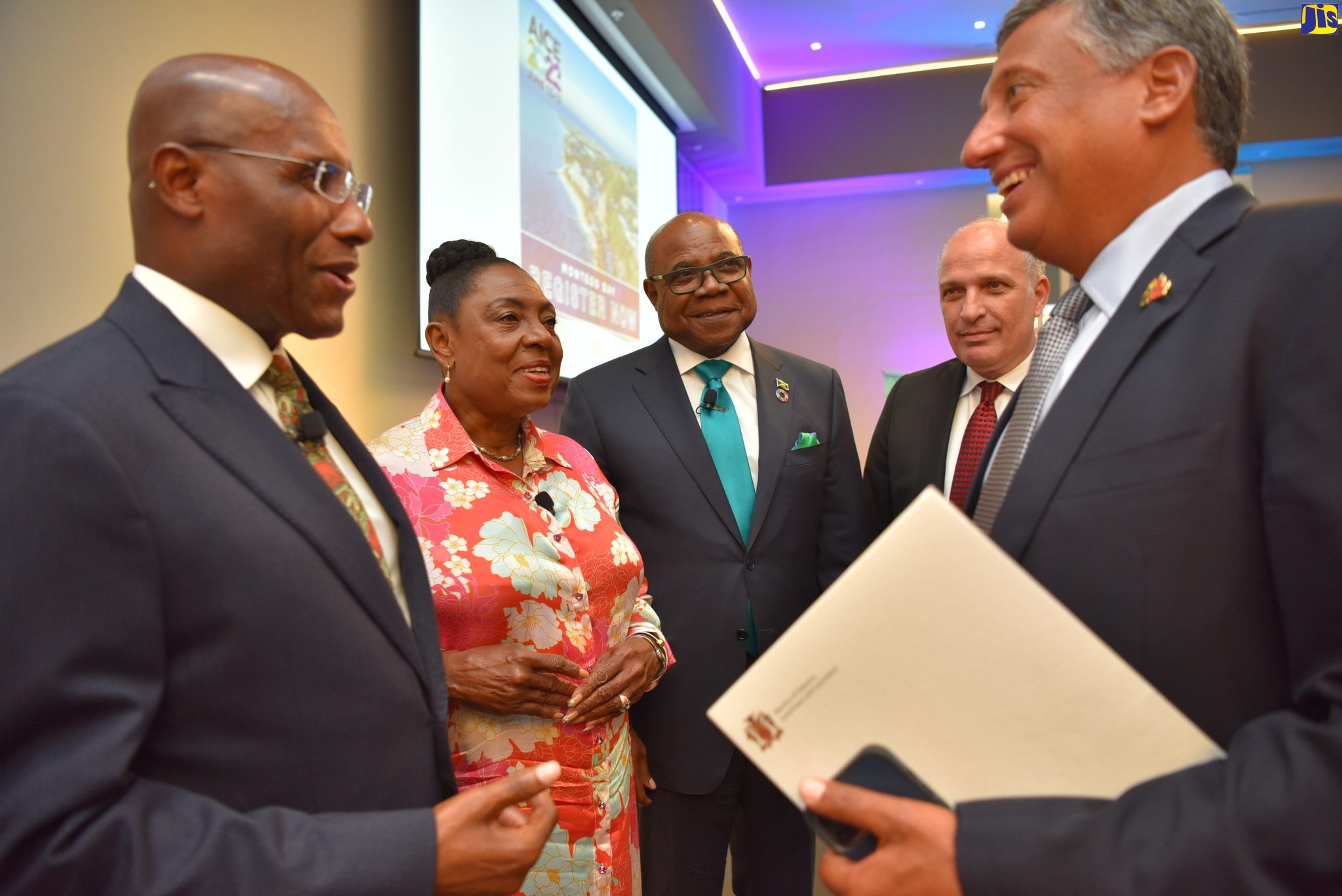 Minister of Industry, Investment and Commerce, Senator the Hon. Aubyn Hill (left), in conversation with Chairman, Jamaica Special Economic Zone Authority, Christopher Levy, during a ceremony at the AC Hotel by Marriot Kingston on Wednesday (April 13) held to provide an update on the staging of the World Free Zones Organization (World FZO) eighth Annual International Conference and Exhibition (AICE 2022). Sharing in the moment (from second left) are Minister of Culture, Gender, Entertainment and Sport, Hon. Olivia Grange; Minister of Tourism, Edmund Bartlett and Chief Executive Officer, World Free Zones Organization, Dr. Samir Hamrouni. The Annual International Conference & Exhibition (AICE) 2022 is scheduled for June 13 to 17 at the Montego Bay Convention Centre in Rose Hall, St. James. More than 1,000 persons from 157 countries are expected to attend the event.