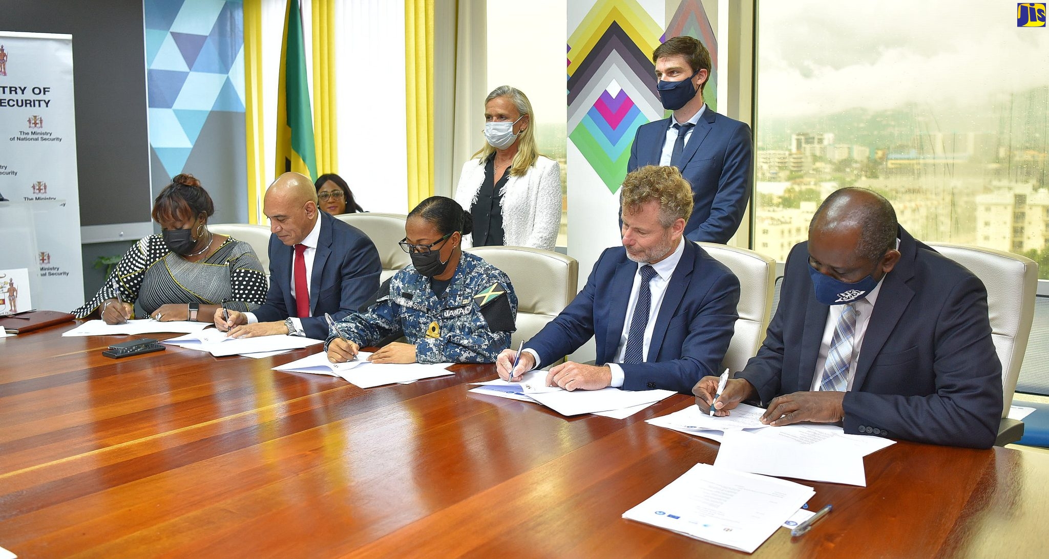 Permanent Secretary in the Ministry of National Security, Courtney Williams (right), participates in the official signing of the Seaport Cooperation Project (SEACOP) Memorandum of Understanding between the European Union and the Ministry of National Security, on Tuesday (April 26). Also signing (from left) are  Director, Intelligence, Jamaica Customs Agency, Kalista Powell; Police Commissioner, Major General Antony Anderson; Chief of Defence Staff,  Rear Admiral Antonette Wemyss Gorman; and  Director of the Seaport Cooperation Project, Dominique Bucas.  The project aims to contribute to the fight against illicit maritime trade and associated criminal networks in targeted countries of the Caribbean, such as Jamaica.