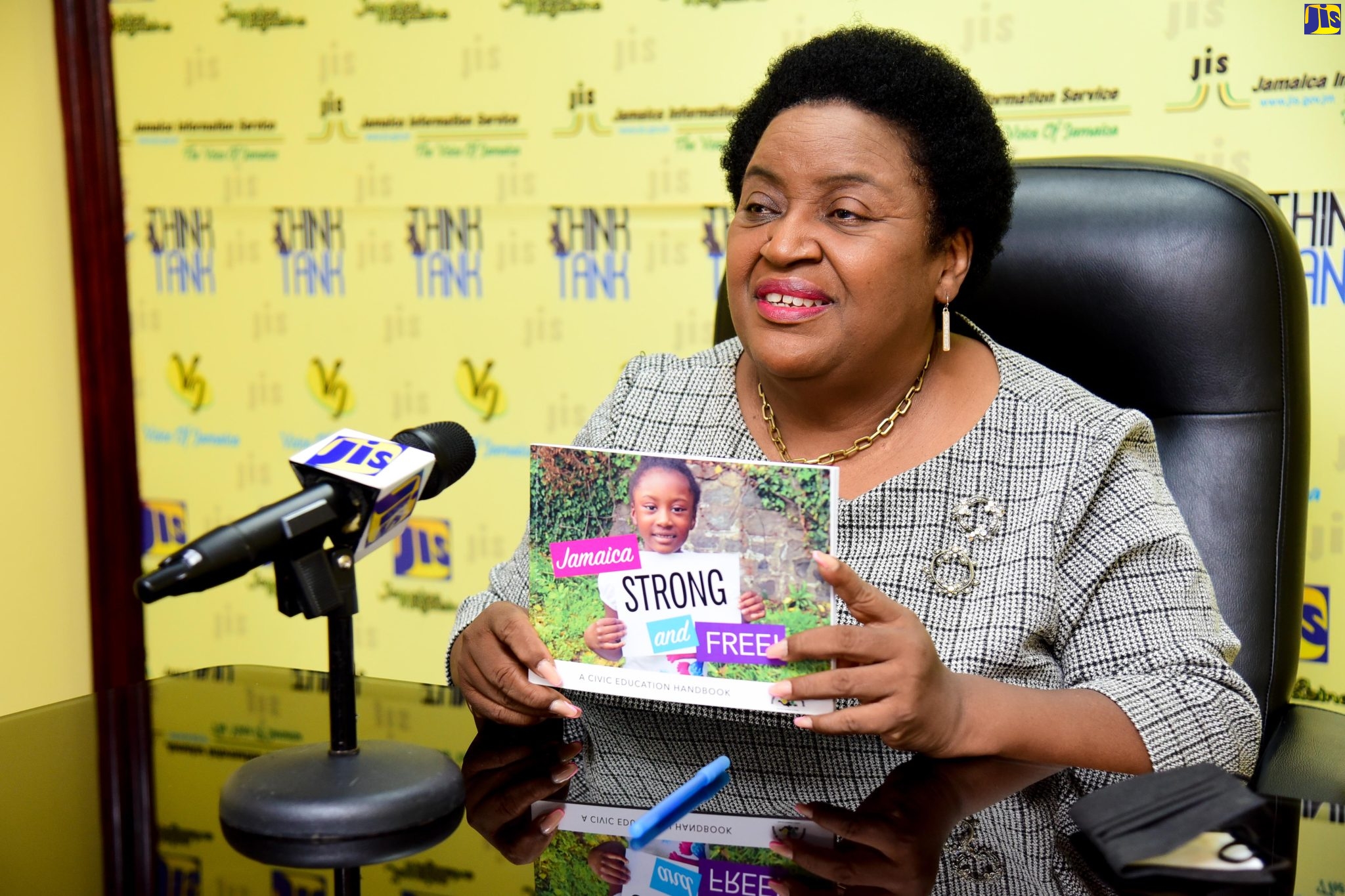 Political Ombudsman, Donna Parchment Brown, addresses a JIS ‘Think Tank’, while displaying a copy of the Civic Handbook, titled ‘Jamaica Strong and Free’, today (May 24). 