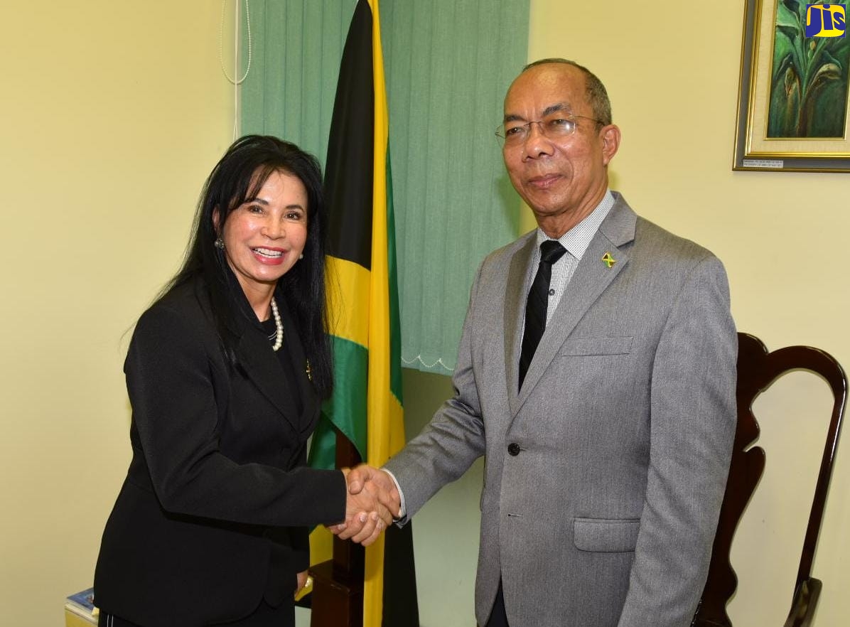Minister of National Security, Hon. Horace Chang (right), exchanges a warm handshake with Ambassador of the Federative Republic of Brazil, Her Excellency Elza de Castro,  who called on the Minister at his Oxford Road offices in St. Andrew on May 5.
