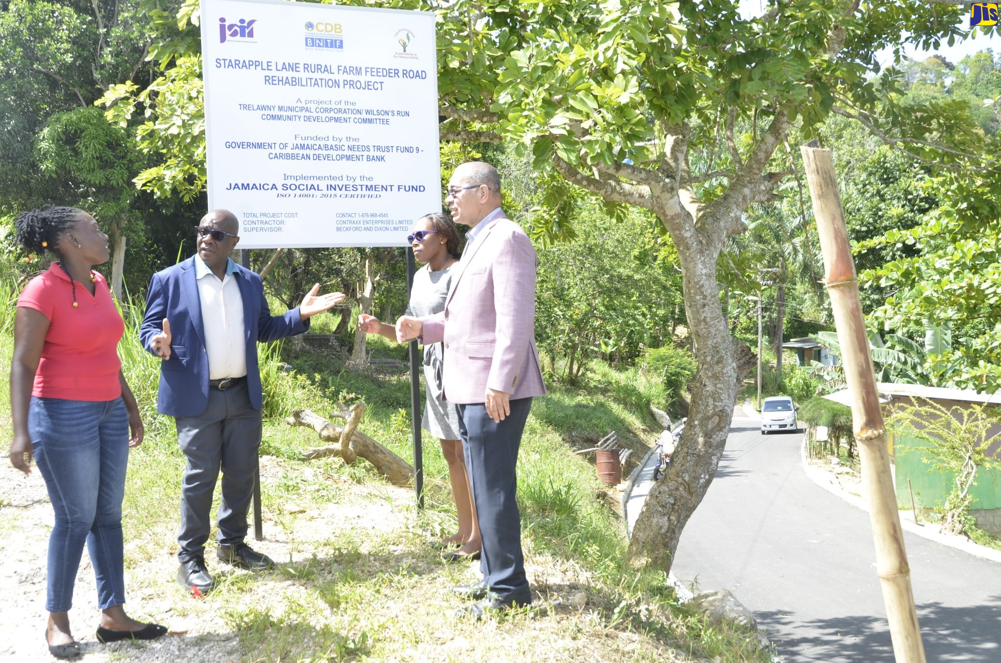 Mayor of Falmouth, Councillor Colin Gager (second left), engages member of the Wilson’s Run Community Development Committee, Kacia Brown (left), following the official handover of Starapple Lane and Common Road in Troy, Trelawny, on Tuesday, May 3. Looking on are Project Manager for the Basic Needs Trust Fund (BNTF), Jamaica Social Investment Fund (JSIF), Dainty Ann Barrett-Smith;  and General Manager for Finance and Procurement at JSIF, Orville Hill. Common Road and Starapple Lane were rehabilitated under a $106-million project implemented by JSIF.