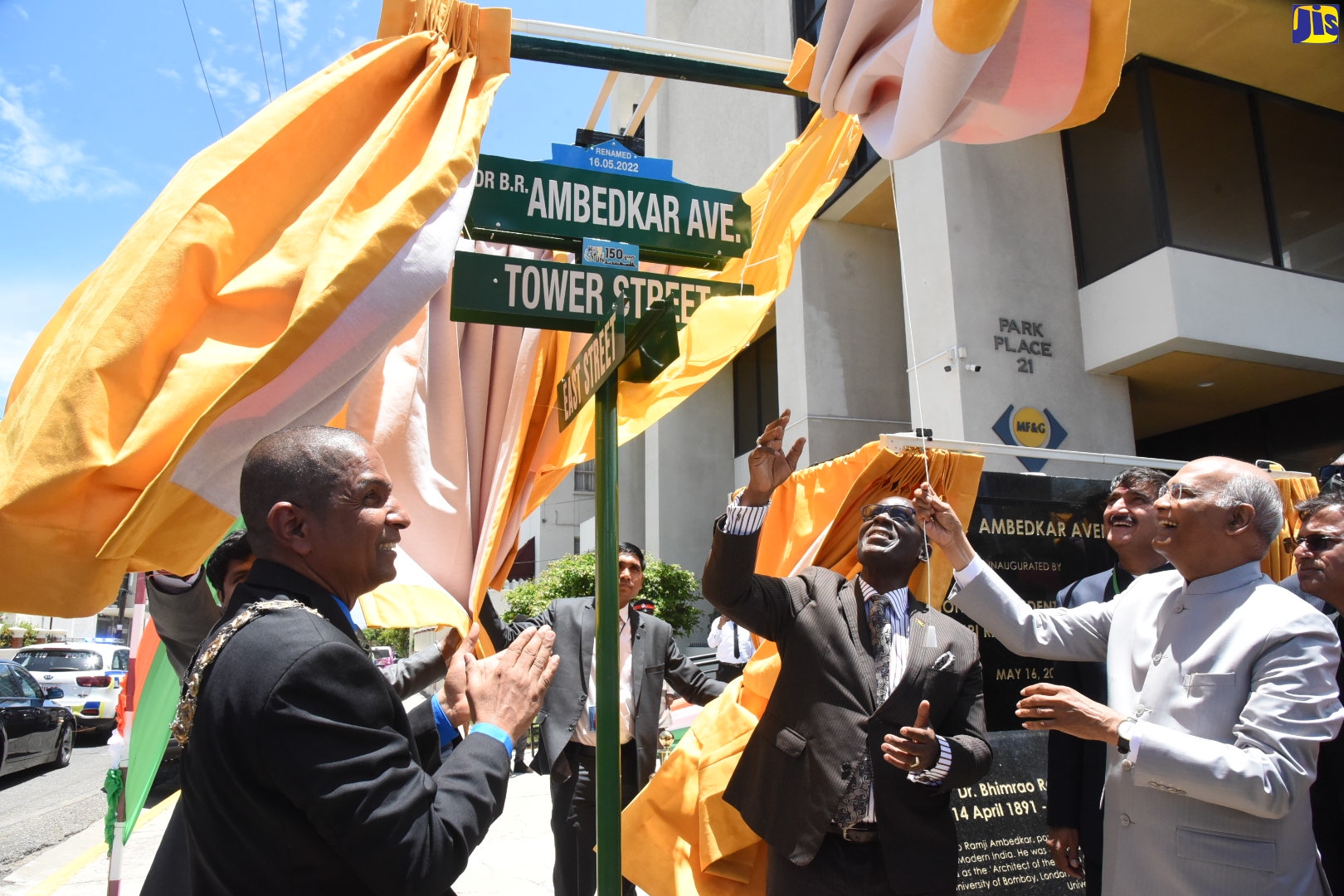 Minister of Local Government and Rural Development, Hon. Desmond McKenzie (second right) and President of the Republic of India, His Excellency the Hon. Ram Nath Kovind (right), unveil the Dr. B.R. Ambedkar Avenue street sign during a ceremony held on Tower Street, today (May 16). At left is Mayor of Kingston, Senator Councillor Delroy Williams.