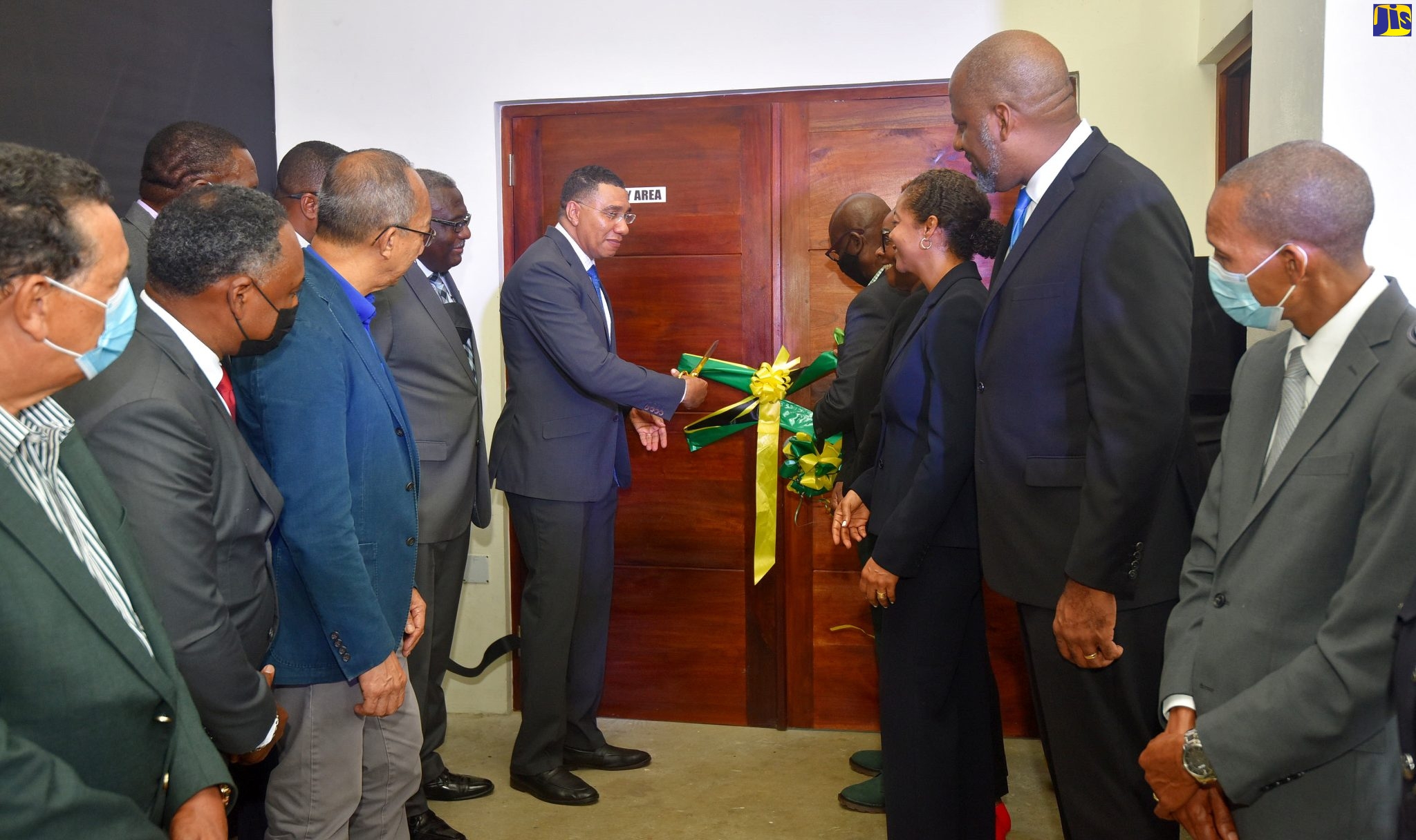 Prime Minister the Most Hon. Andrew Holness (seventh left), cuts the ribbon to officially open the $580 million Jamaica Fire Brigade (JFB) Area 4 Headquarters in Montego Bay, St James. situated at #1 Barnett Street. Assisting him is Minister of Local Government and Rural Development Hon. Desmond McKenzie (fourth right). Sharing the moment are Deputy Prime Minister and Minister of National Security, Hon. Dr. Horace Chang (third left. foreground); Minister of Legal and Constitutional Affairs Marlene Malahoo Forte (third right); and dignitaries from the Jamaica Social Investment Fund (JSIF) and Jamaica Fire Brigade (JFB).