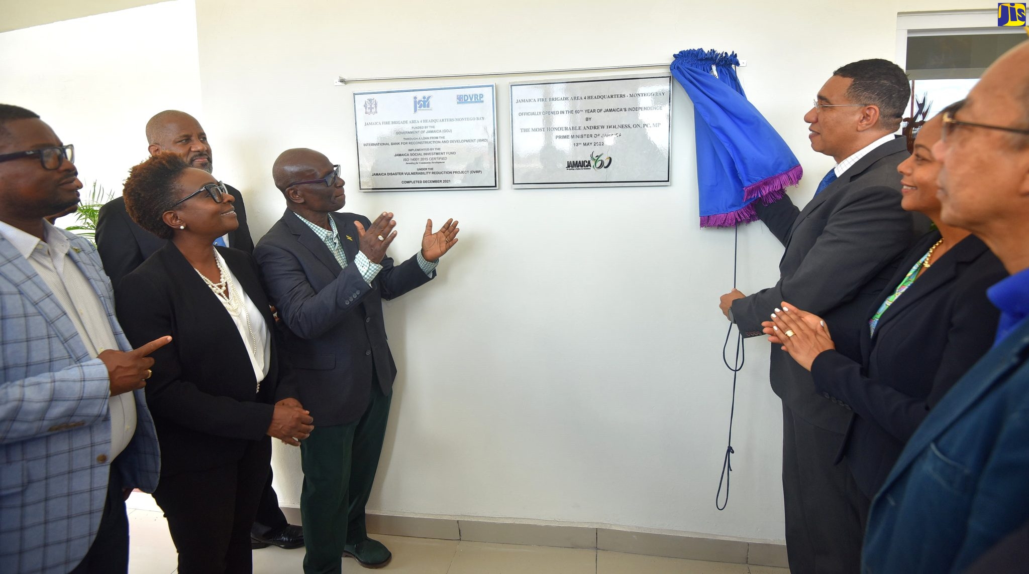 Minister of Local Government and Rural Development Hon. Desmond McKenzie (fourth left) applauds, as Prime Minister the Most Hon. Andrew Holness (third right) unveils plaques to mark the official opening of the Montego Bay Fire Station and Area Four Headquarters of the Jamaica Fire Brigade in St. James on Friday (May 13). Looking on (from left) are Member of Parliament for St. James Central Heroy Clarke; Opposition Spokesperson for Tourism Senator Janice Allen; Chairman of the Jamaica Social Investment Fund (JSIF) Dr. Wayne Henry; Minister of Legal and Constitutional Affairs, Hon Marlene Malahoo Forte and Deputy Prime Minister and Minister of National Security, Dr. Horace Chang.