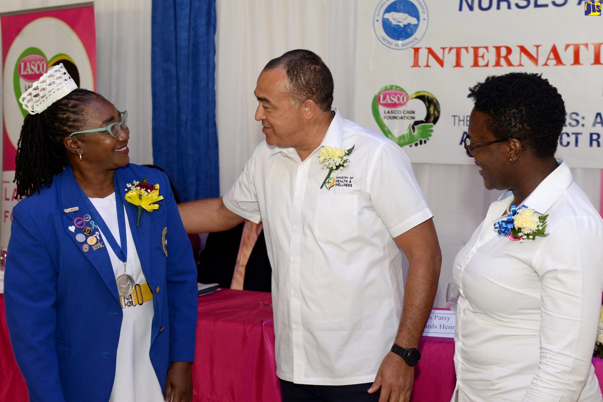 Minister of Health and Wellness, Dr. the Hon. Christopher Tufton (centre), greets President of the Nurses Association of Jamaica (NAJ), Patsy Edwards-Henry (left), at the launch of National Nurses Week and International Nurses Day at the Terra Nova All-Suite Hotel in St. Andrew on May 12. At right is Operations and Programme Manager, LASCO Chin Foundation, Tahirah Fraser.