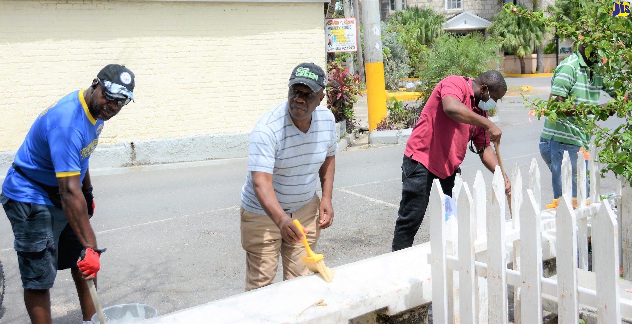 Chairman of the Trelawny Municipal Corporation and Mayor of Falmouth, Councillor Colin Gager (second left), is joined by members of the Corporation’s Roads and Works Department in painting a wall in Water Square, Falmouth, on Labour Day, May 23.