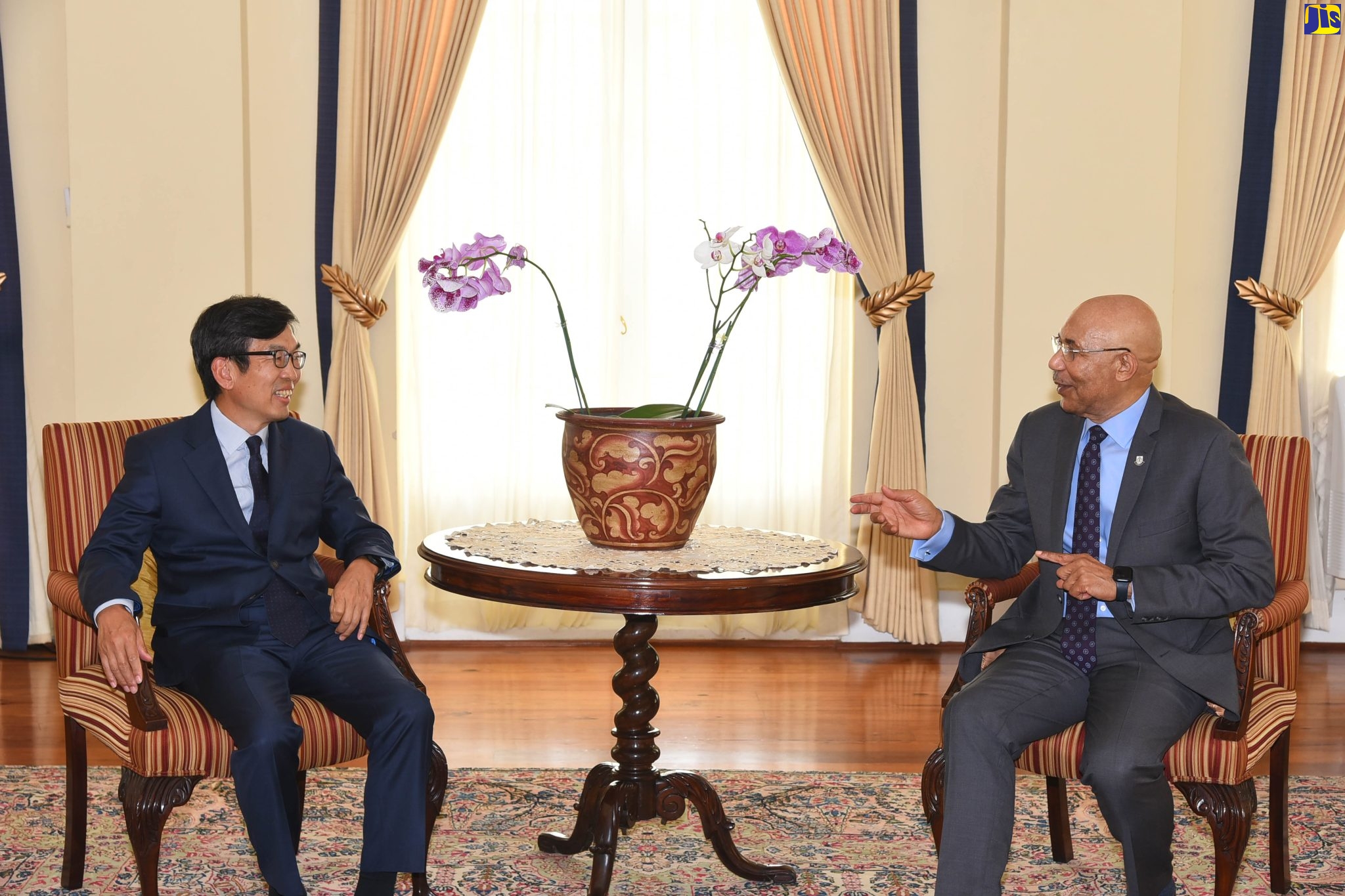 Governor-General, His Excellency the Most Hon. Sir Patrick Allen (right), engages in light conversation with Ambassador of the Republic of Korea, His Excellency Suh Jeong-In, during a courtesy call at King’s House on May 11. Jamaica and Korea are celebrating  60 years of diplomatic relations this year.