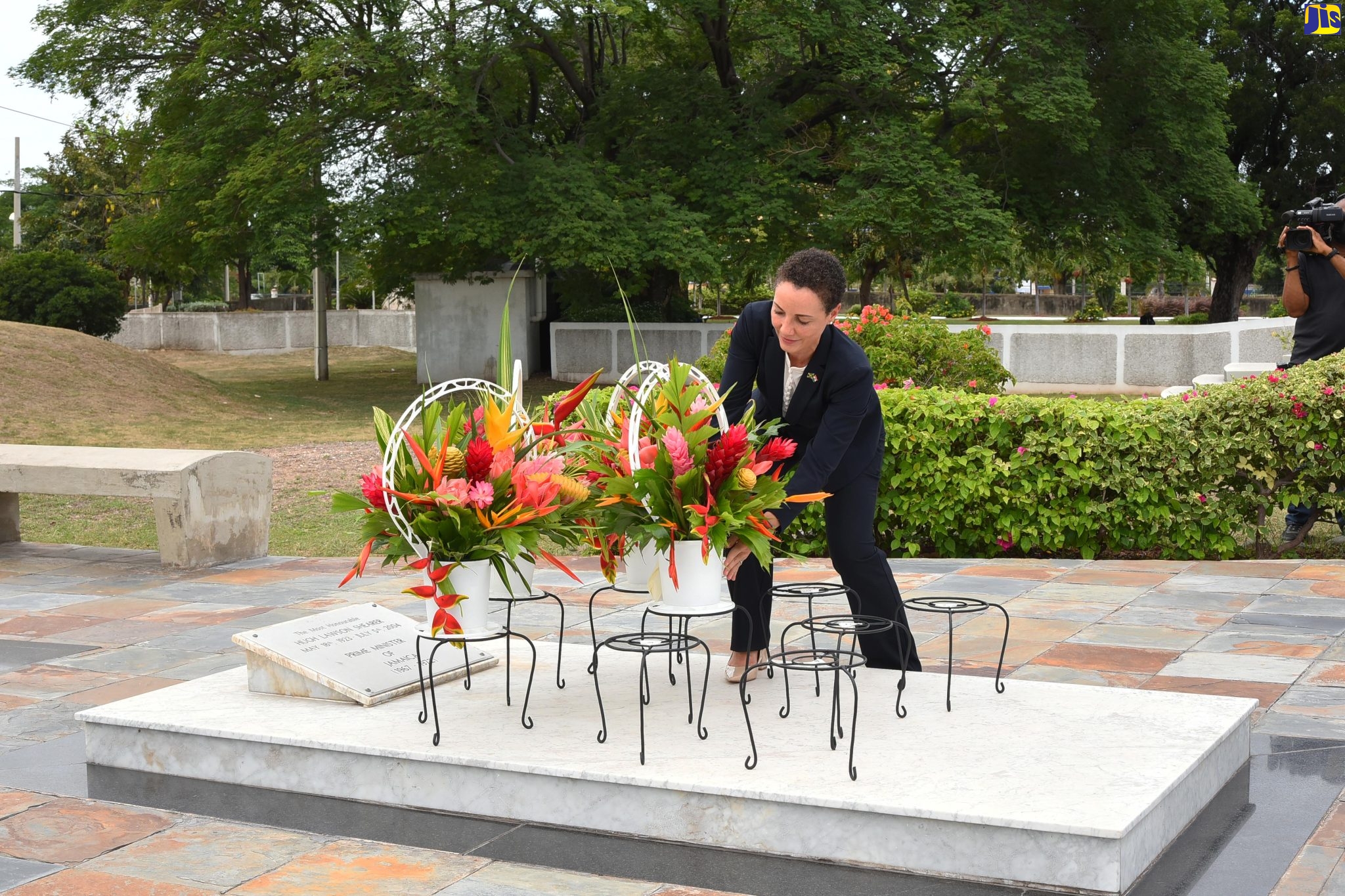 Foreign Affairs and Foreign Trade Minister, Senator the Hon. Kamina Johnson-Smith places flowers on the grave of late former Prime Minister, the Most Hon. Hugh Lawson Shearer. Occasion was a floral tribute held at National Heroes Park on May 18, to mark the 99th anniversary of his birth.