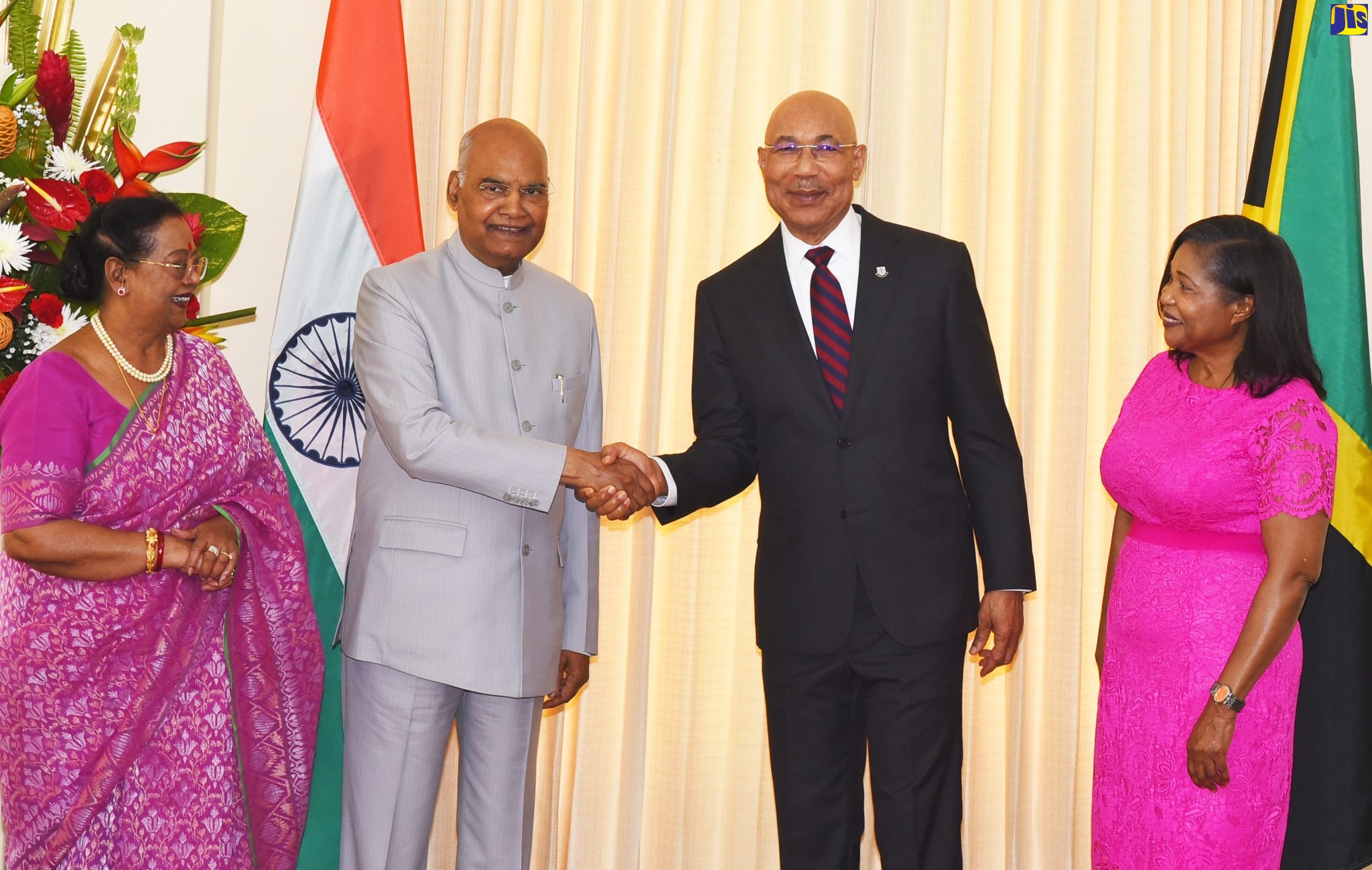 Governor-General, His Excellency the Most Hon. Sir Patrick Allen (standing right), observes as President of the Republic of India, His Excellency the Hon. Ram Nath Kovind (seated), signs the guest book during his visit to King