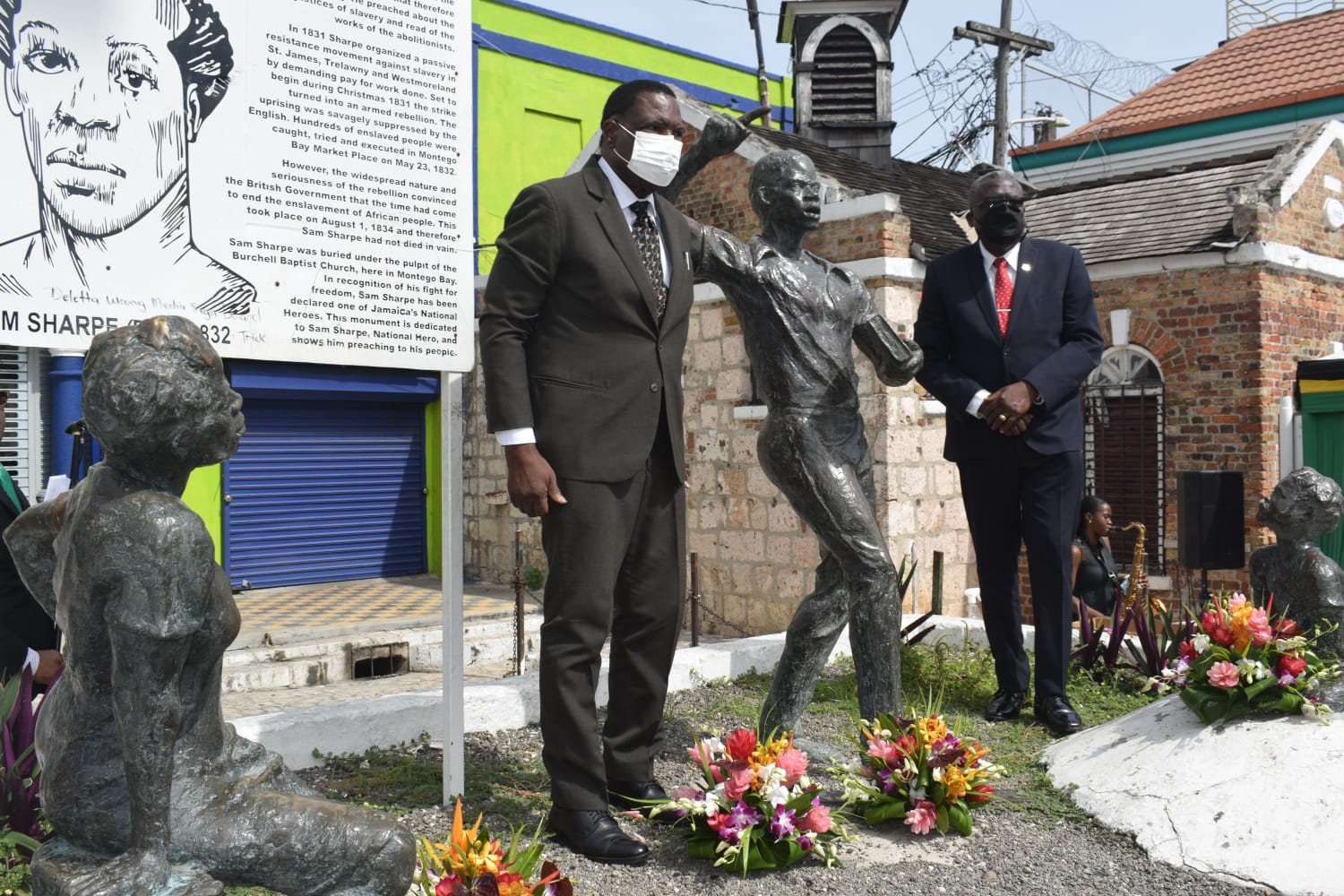 Mayor of Montego Bay, Councillor Leeroy Williams (left), and Custos of St. James, Bishop the Hon. Conrad Pitkin, pay respects to National Hero, The Right Excellent Samuel Sharpe, at a floral tribute at Sam Sharpe Square in Montego Bay on Monday, May 23.