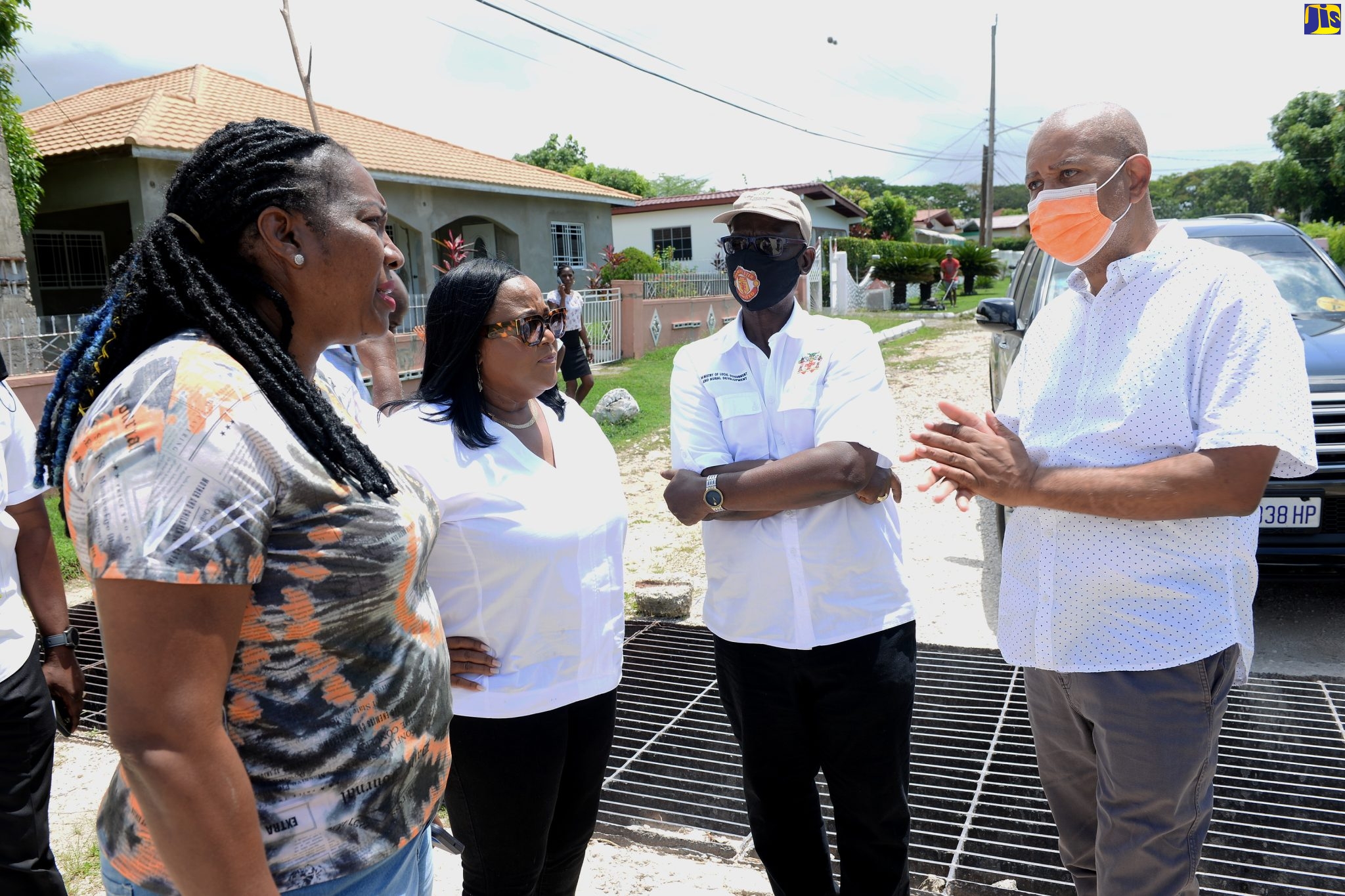 Minister of Local Government and Rural Development, Hon. Desmond McKenzie (second right), in discussion with (from left) Councillor, Angels Division, Patricia Harris; Member of Parliament, St. Catherine North Central, Natalie Neita Garvey; and Mayor of Spanish Town, Councillor Norman Scott, during a tour of several communities in St. Catherine North Central, recently.