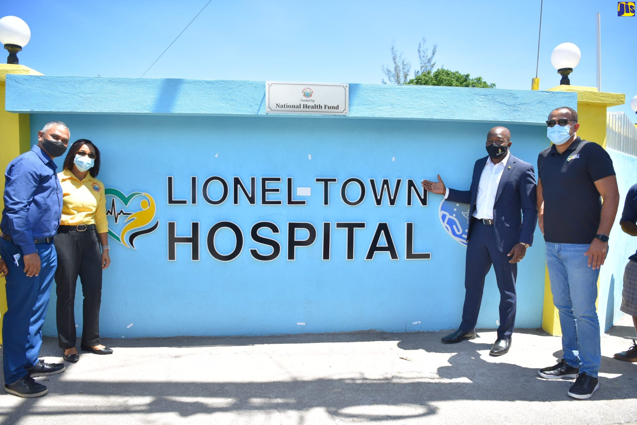 From Left, Vice Chairman of the Southern Regional Health Authority, Michael Stern; Director Health Promotion, PR & Customer Care – National Health Fund, Shermaine Robotham; Minister of Agriculture and Fisheries, Hon. Pearnel Charles Jr.; and Minister of Health and Wellness, Dr. the Hon. Christopher Tufton, unveil the sign for the new perimeter wall at Lionel Town Hospital on Friday (April 22).