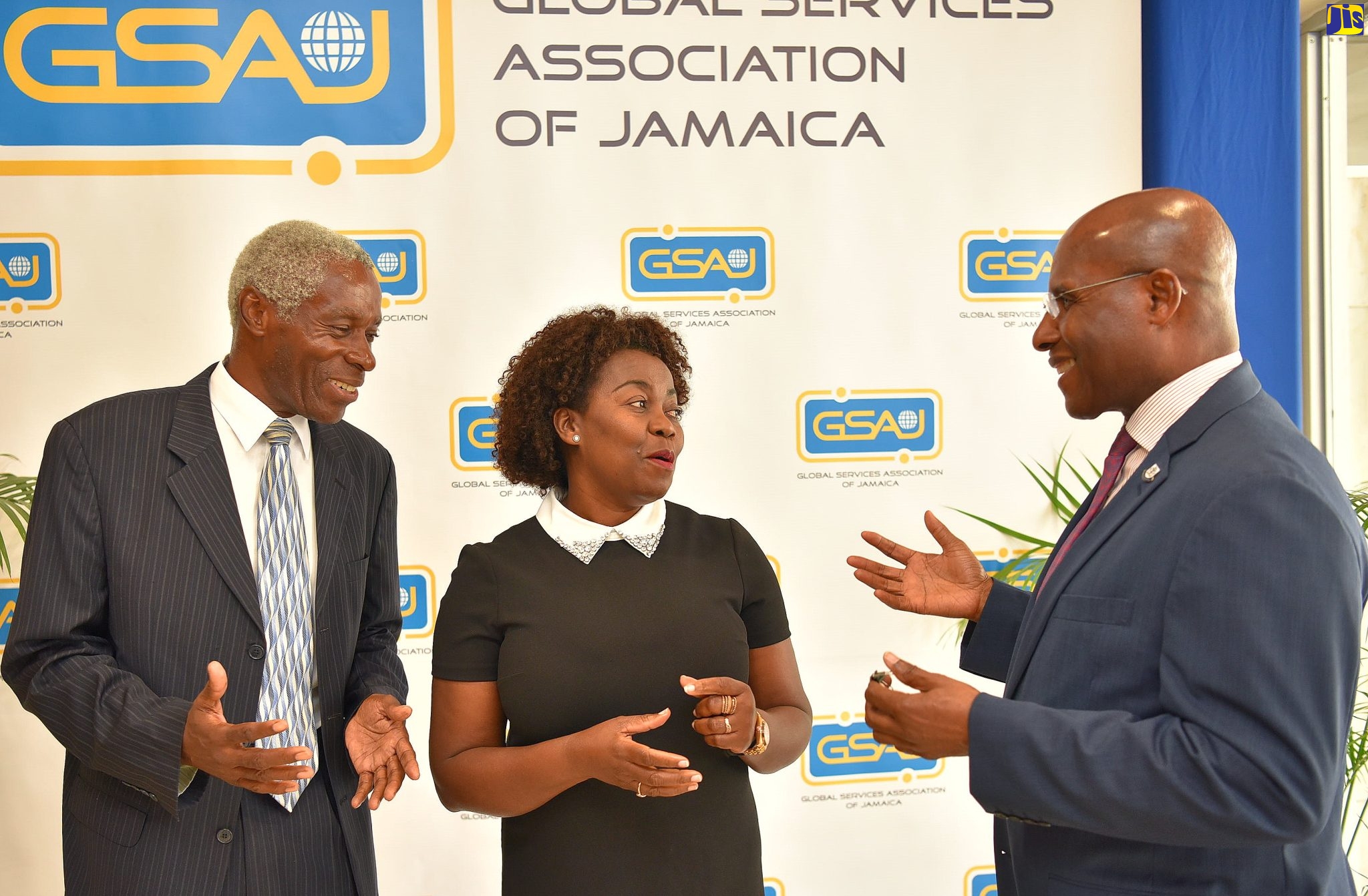 Minister of Industry, Investment and Commerce, Senator the Hon. Aubyn Hill (right), converses with (from left)  Chairman, HEART/NSTA Trust, Professor Alvin Wint, and President, Global Services Association of Jamaica (GSAJ), Gloria Henry, during the GSAJ
