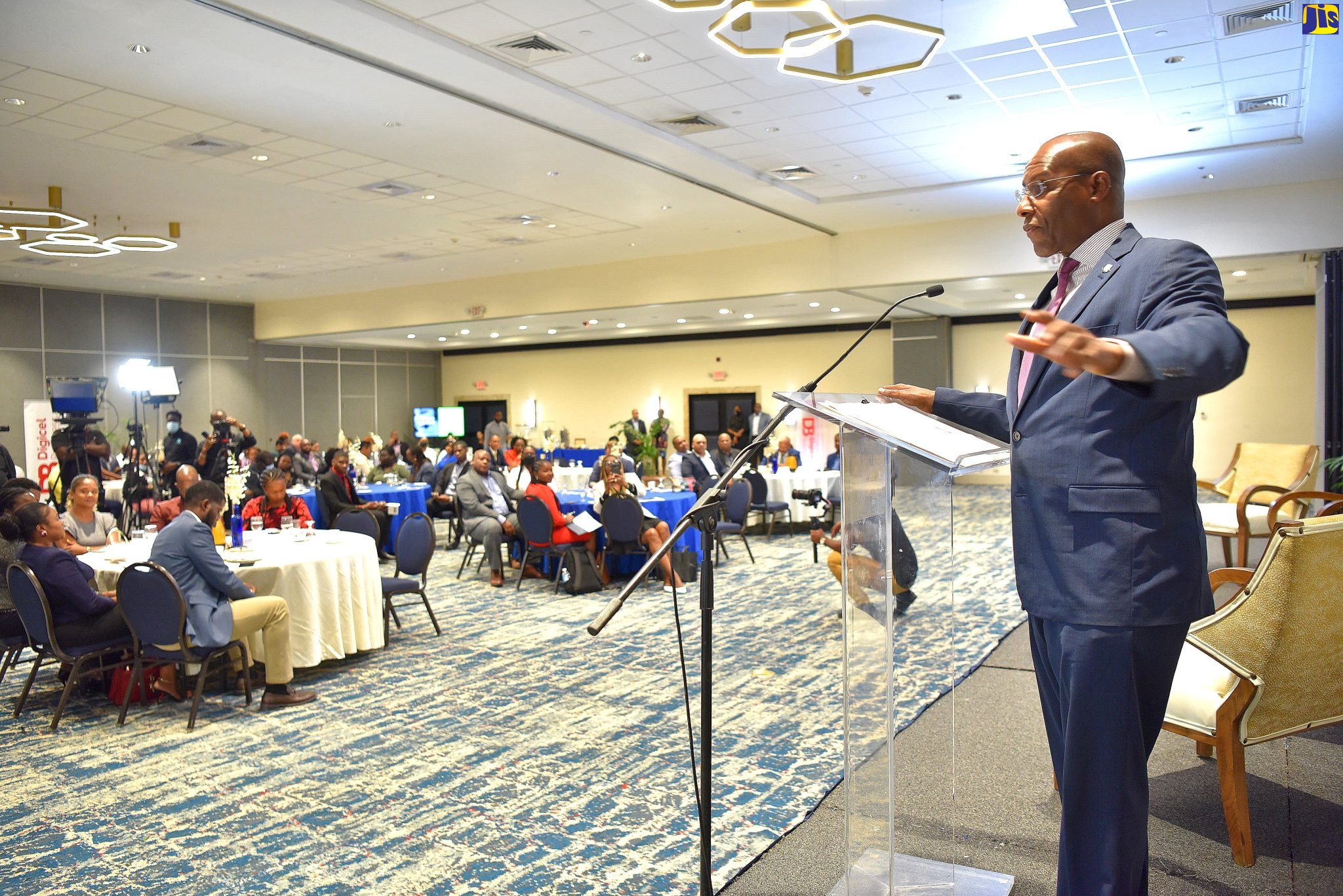 Minister of Industry, Investment and Commerce, Senator the Hon. Aubyn Hill (right), addressing the Global Services Association of Jamaica (GSAJ) Outsource2Jamaica Glance 22 forum on Tuesday (May 17). The event was held at The Jamaica Pegasus hotel in New Kingston.