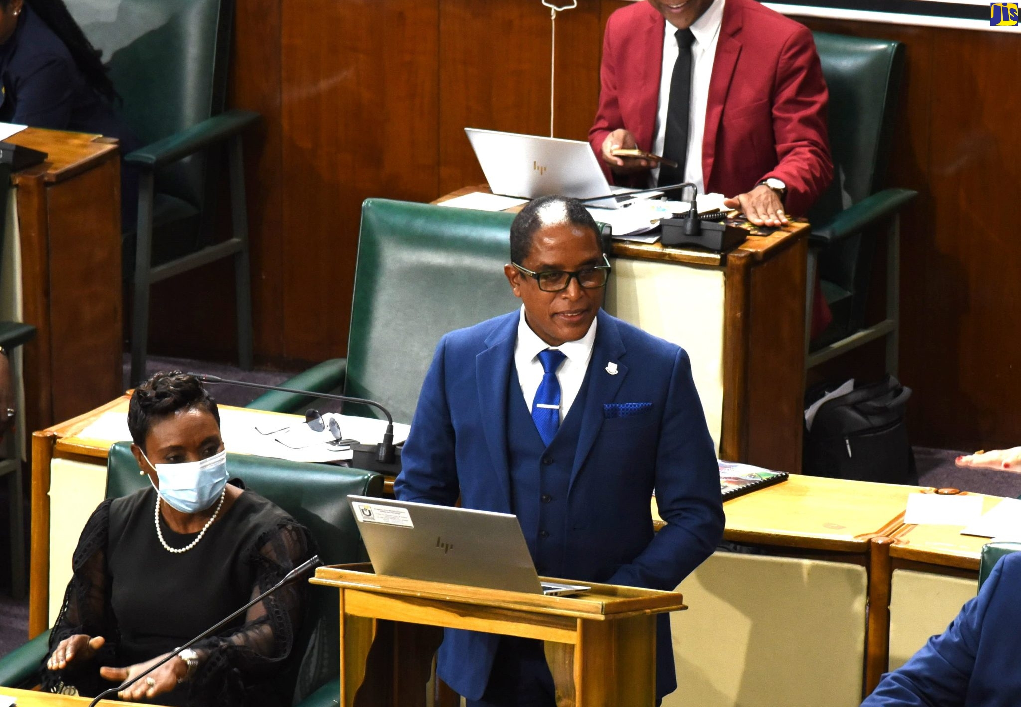 State Minister in the Ministry of Industry, Investment and Commerce, Dr. the Hon. Norman Dunn, makes his contribution to the  2022/23 Sectoral Debate in the House of Representatives, recently. Seated at left is Minister of State in the Ministry of Health and Wellness, Hon. Juliet Cuthbert-Flynn.