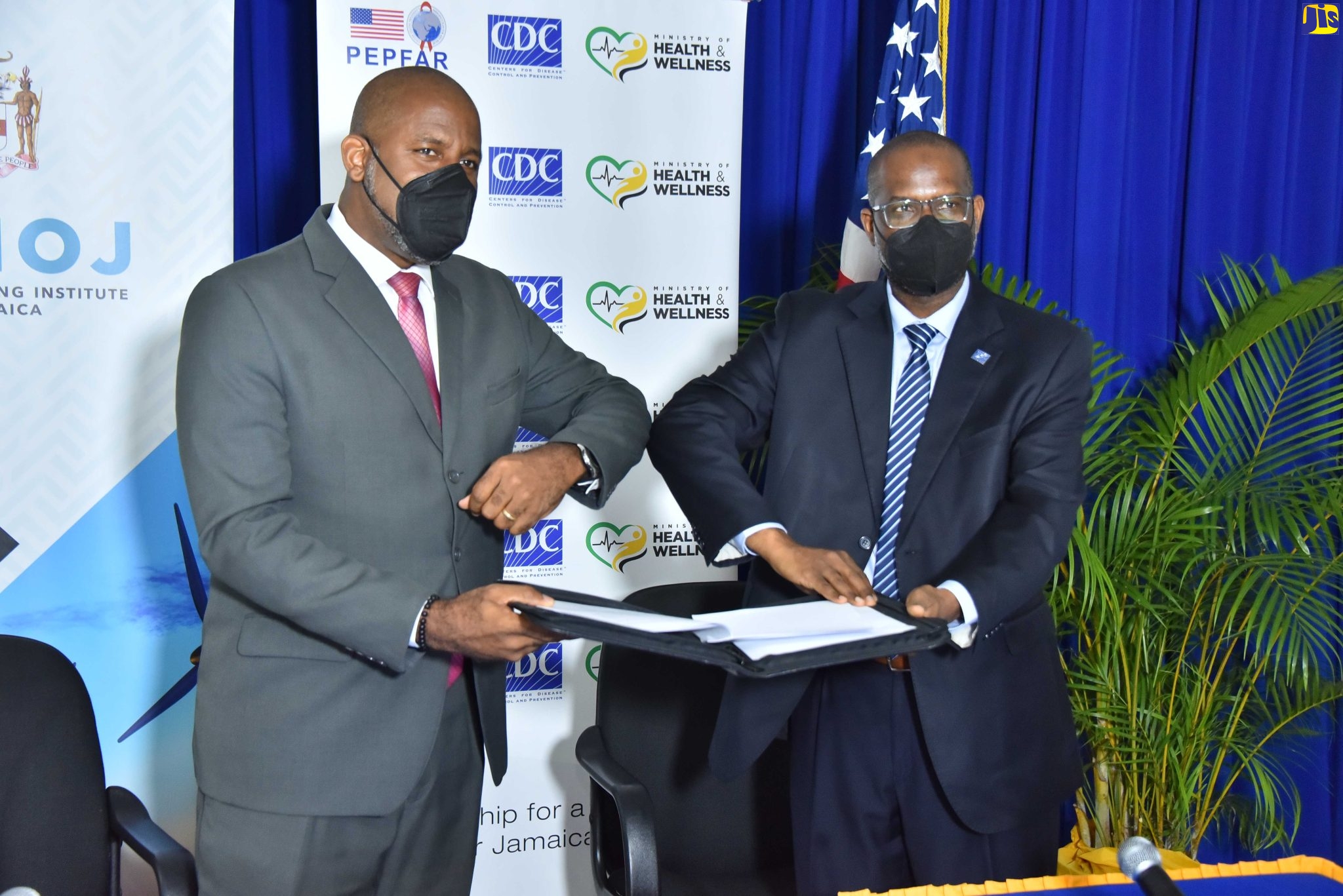 Director General, Planning Institute of Jamaica (PIOJ), Dr. Wayne Henry (left) and Director, Centers for Disease Control and Prevention (CDC), Caribbean Regional Office, Dr. Varough Deyde display the signed letter of intent and data sharing agreement, during a recent ceremony for the Jamaica Children and Youth Health and Well-being Study (CHEWS-JA), held at the PIOJ’s corporate offices, St. Andrew. The survey is a national household tool designed to collect population data and analyse it to draw recommendations for developing more targeted and informed policy initiatives.