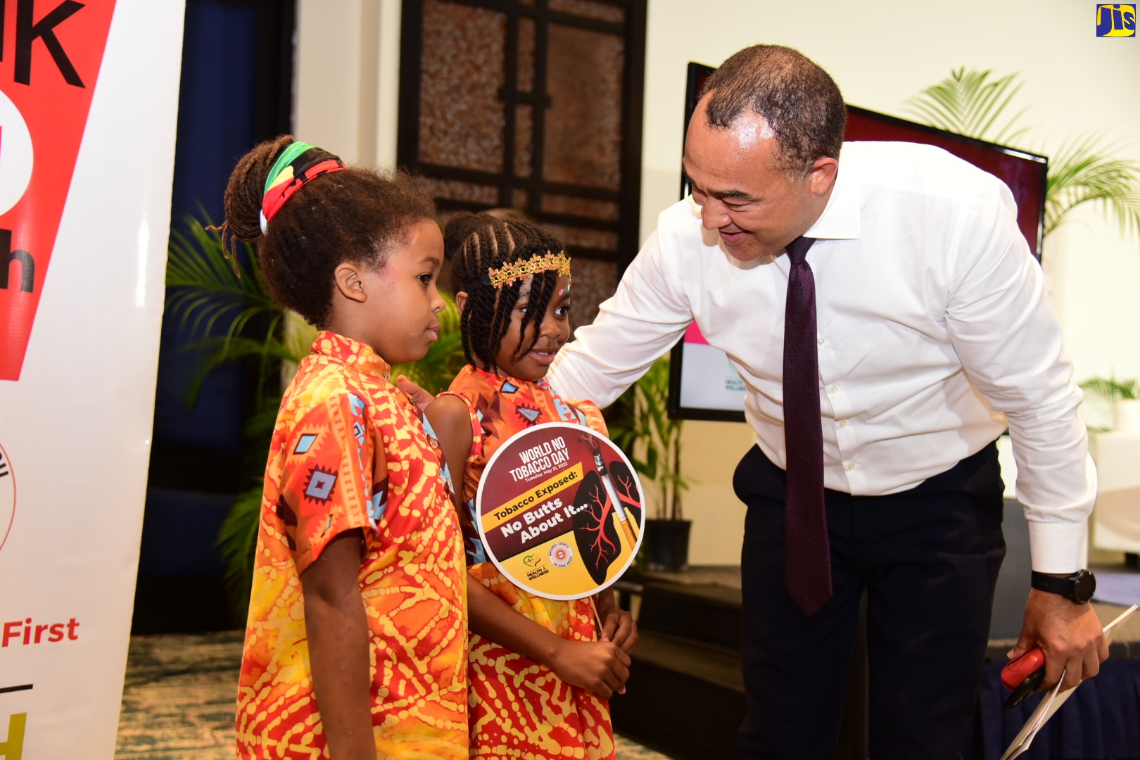 Minister of Health and Wellness, Dr. the Hon. Christopher Tufton, commends Tafari (l) and Ngozi Wright on their performance at the World No Tobacco Day Youth Forum held on Tuesday (May 31) at The Jamaica Pegasus hotel in New Kingston under the theme ‘Tobacco Exposed : ‘No Butts About It’.