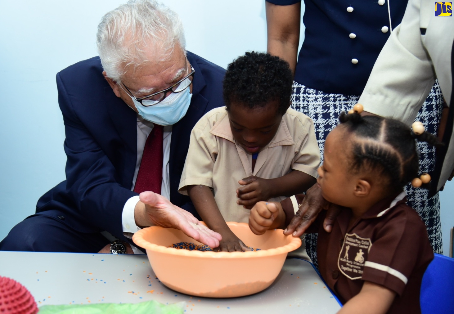Minister of Labour and Social Security, Hon. Karl Samuda, interacts with students of the Early Stimulation Programme (ESP), Kaylee Ellis and Antoine Allen, at the opening of ESP’s sensation station, in Kingston, on May 31.