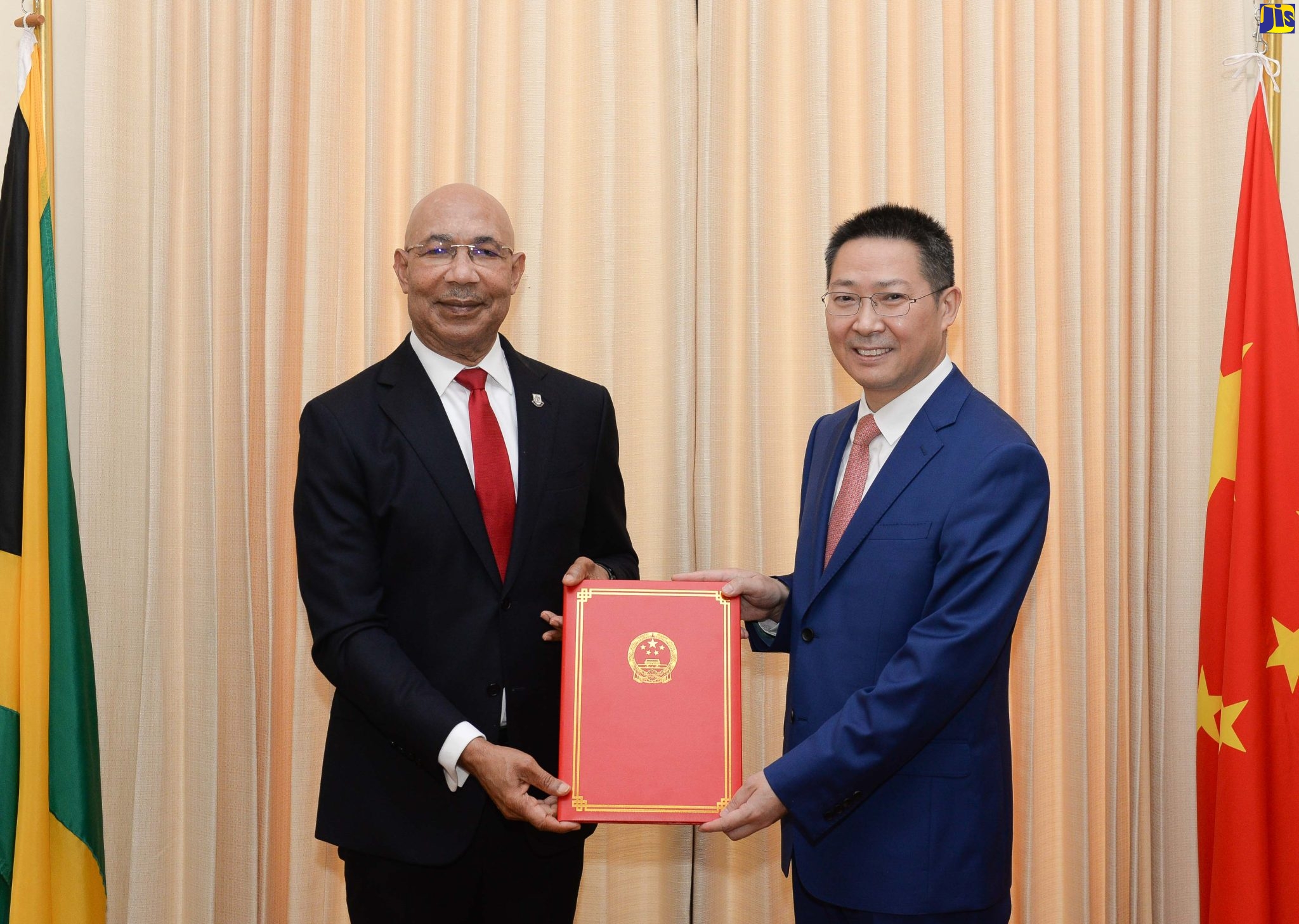Governor General, His Excellency the Most Hon. Sir Patrick Allen (left), accepts Letters of Credence from Ambassador-designate of the People’s Republic of China,  Daojiang Chen, during a courtesy call at King’s House on June 17.