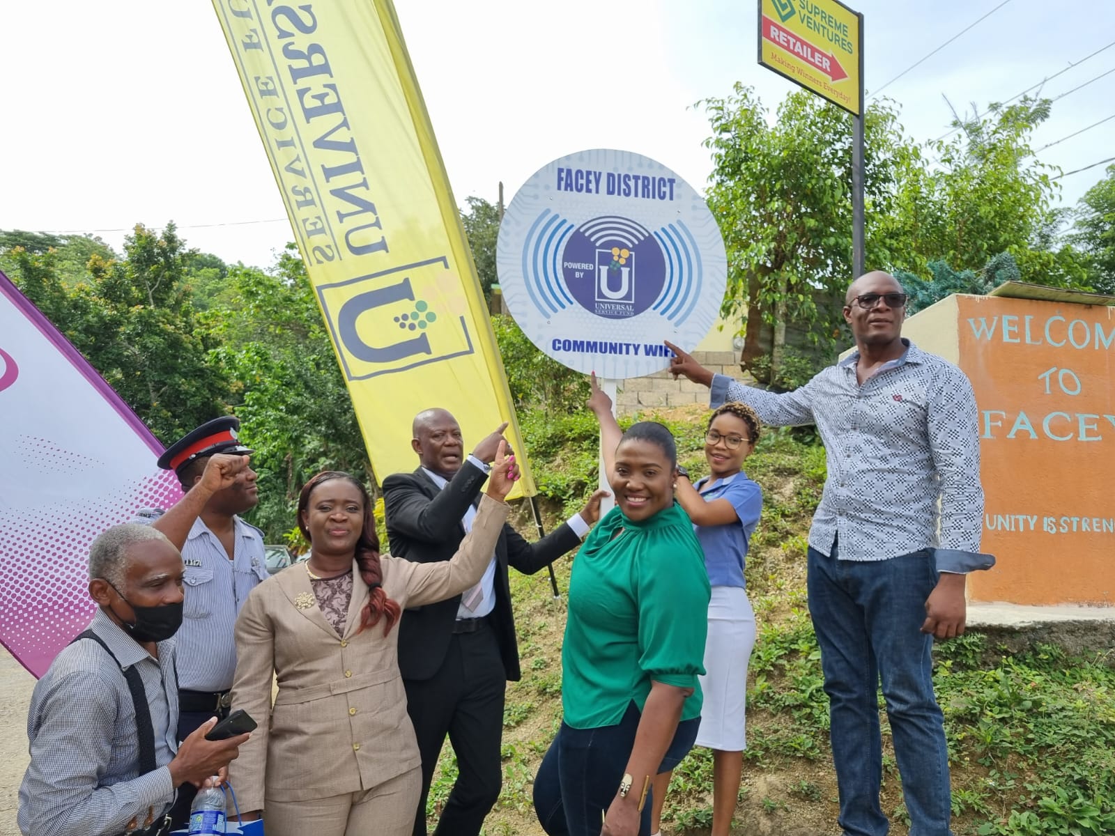 Chief Executive Officer of the Universal Service Fund (USF) Daniel Dawes (fourth left), and Member of Parliament for St. Catherine North Eastern Kerensia Morrison (third right), celebrate the recent commissioning of a free secured wi-fi hotspot, in the deep rural community of Facey, in St. Catherine. Others pictured from left are; Vice President of the Community Development Committee (CDC), Alex Walker; Constable Troy Christian; teacher at the Troja Primary and Infant School, Paula Duncan Frater; Administrative Assistant at Konnexx Services, Jodian Gokhul; and Community Liaison, Robert Grandison. 