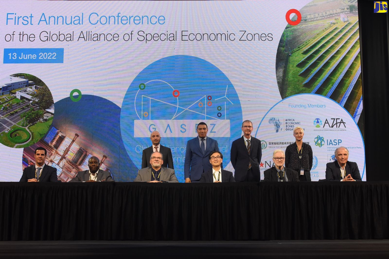 Prime Minister, the Most Hon. Andrew Holness (second left, standing), and Chairperson of the World Free Zones Organization (WFZO), Dr. Mohammed Al Zarooni (left, standing),  with an international delegation and founding members who signed the MOU for the establishment and launch of the Global Alliance for Special Economic Zones (GASEZ) Conference, at the Montego Bay Convention Centre, in Rose Hall, St James, on Monday (June 13).