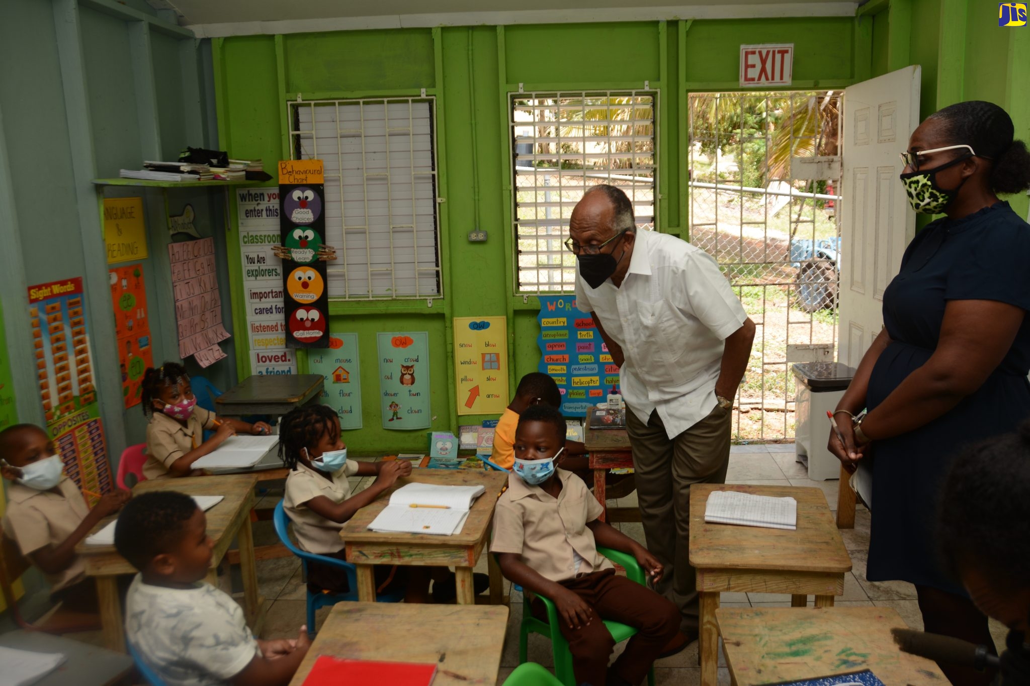 Chairman of the Jamaica Education Transformation Commission (JETC), Professor Orlando Patterson (left), interacts with students of  the Toddlers Learning Centre in Scarlett Hall, St. Ann, during a visit to the institution on Friday, June 3.  Teacher, Sherene Davis, looks on.