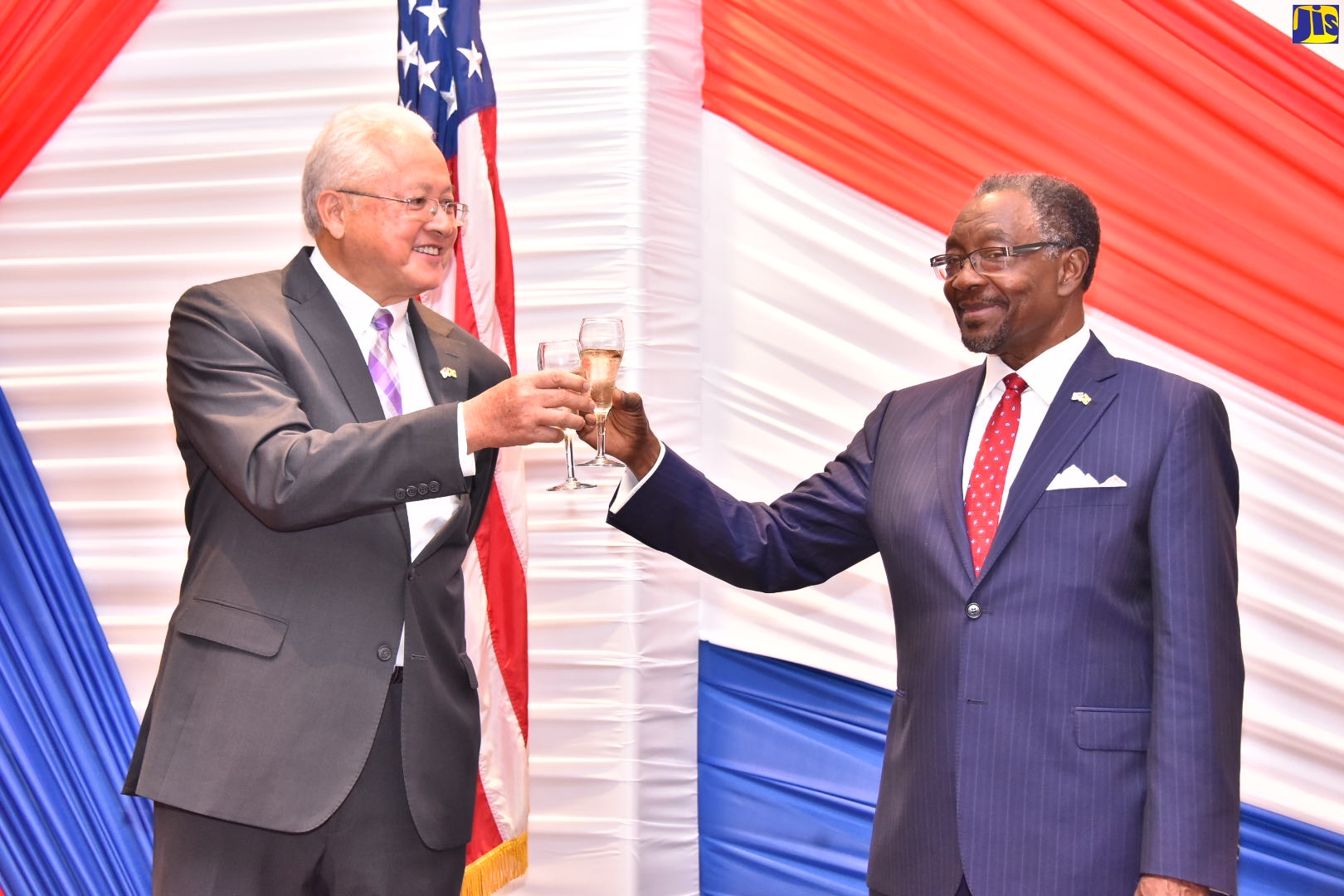 Justice Minister, Hon. Delroy Chuck (left), and Ambassador of the United States of America (USA) to Jamaica, His Excellency Nick Perry, raise their glasses in a toast to commemorate the USA’s 246th anniversary of Independence, during a reception held on June 28 at the Jamaica Pegasus Hotel, in New Kingston.