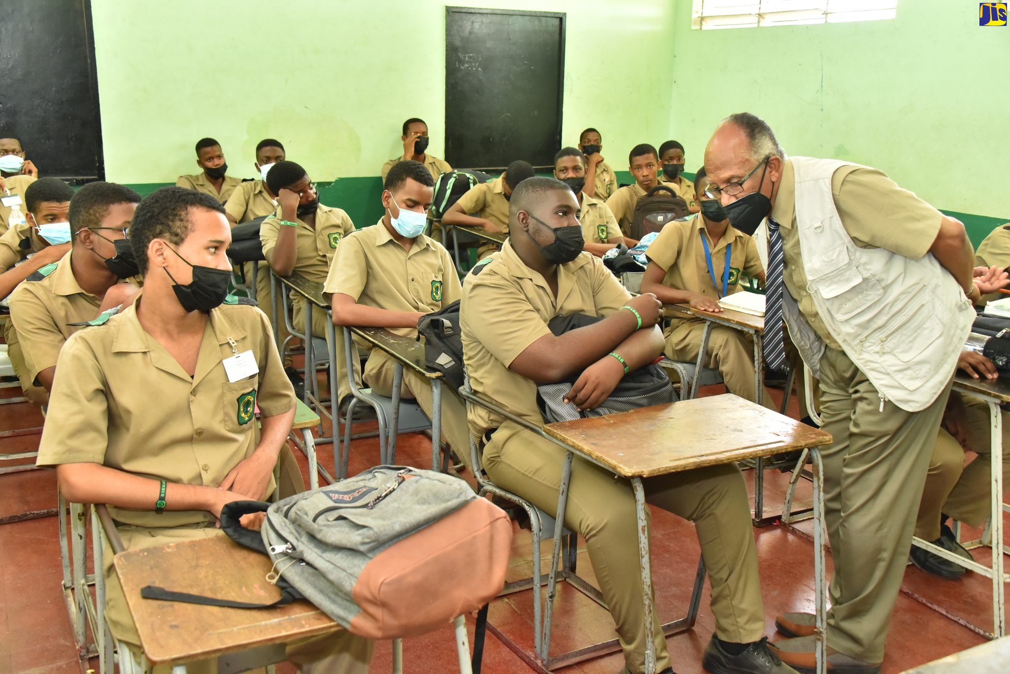 Chairman of the Jamaica Education Transformation Commission (JETC), Professor Orlando Patterson (right), engages with students of the Calabar High School, St. Andrew, during a recent visit to the institution.