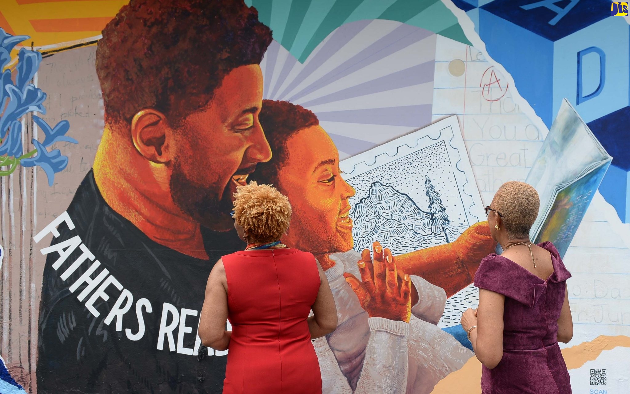 Minister of Education and Youth, Hon. Fayval Williams (right) and Permanent Secretary (Acting) in the Ministry Maureen Dwyer examine aspects of the artwork in tribute to fathers following its official unveiling along Church Street, downtown Kingston on Father’s Day (June 19). The mural forms part of the