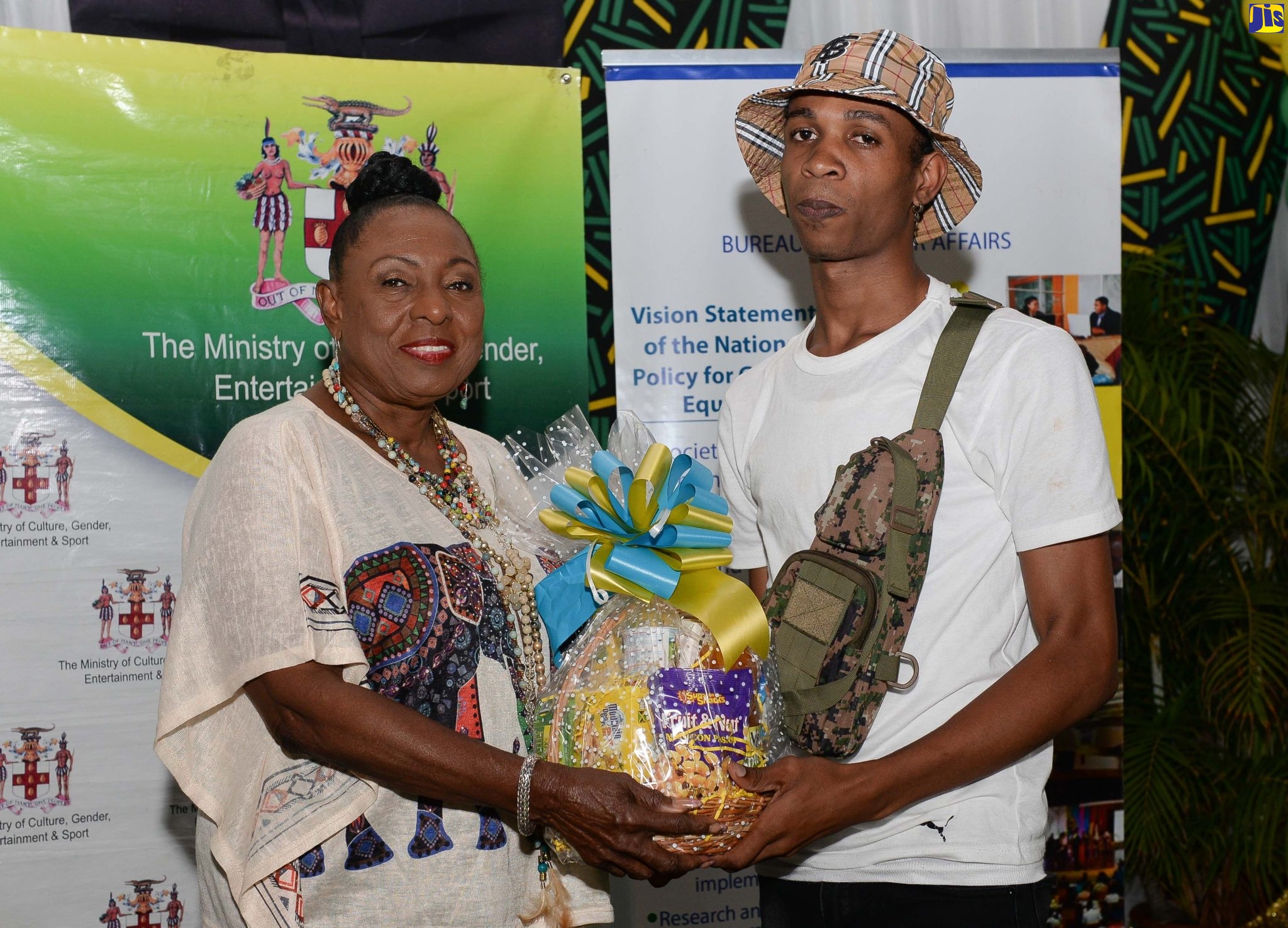 Minister of Culture, Gender, Entertainment and Sport, Hon. Olivia Grange (left) presents a plaque to Women Centre of Jamaica Foundation (WCJF) adolescent programme participant, Tadj Rass, at the Ministry’s annual Outstanding Fathers Awards held on Friday (June 17) at the Caymanas Golf Club, St. Catherine. It is one of several events organised by the Ministry’s Bureau of Gender Affairs to mark this year’s Father’s Day which will be celebrated on Sunday (June 19).
