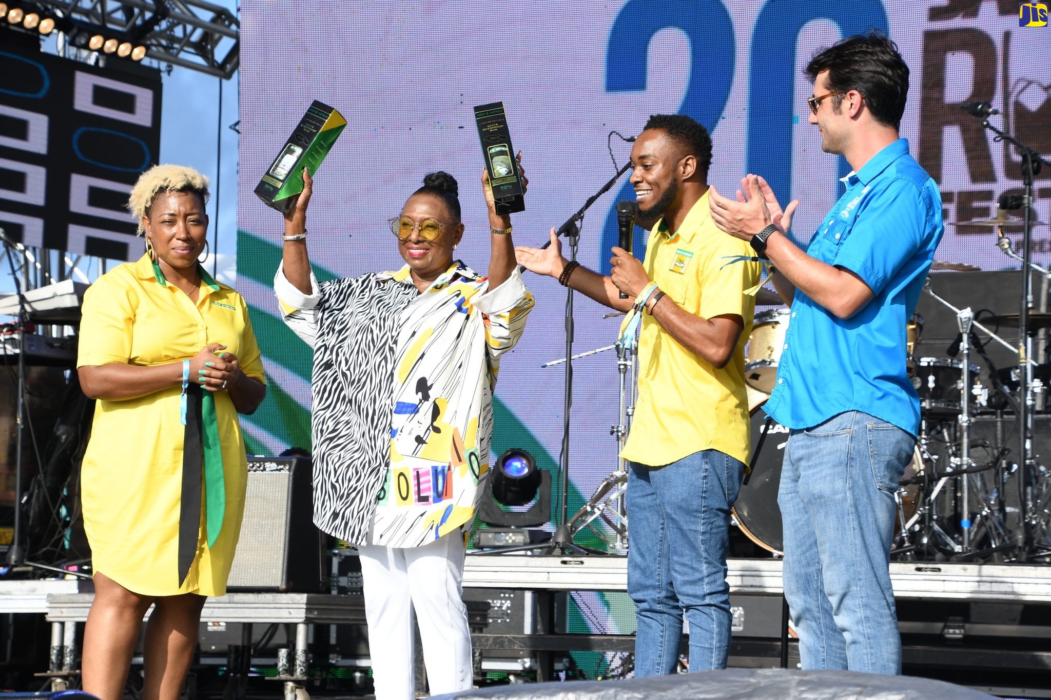 Minister of Culture, Gender, Entertainment and Sport, Hon. Olivia Grange (second left), displays limited edition Wray and Nephew White Overproof Rum presented to her during the fourth staging of the Jamaica Rum Festival at the Aqueduct in Rose Hall, St. James, on Saturday (June 25). Looking on (from left) are J. Wray and Nephew Limited’s Jamaica and Caribbean Brand Manager, Sasha Warner-Campbell, Marketing Manager, Pavel Smith, and Marketing Director, Pietro Gramegna.
