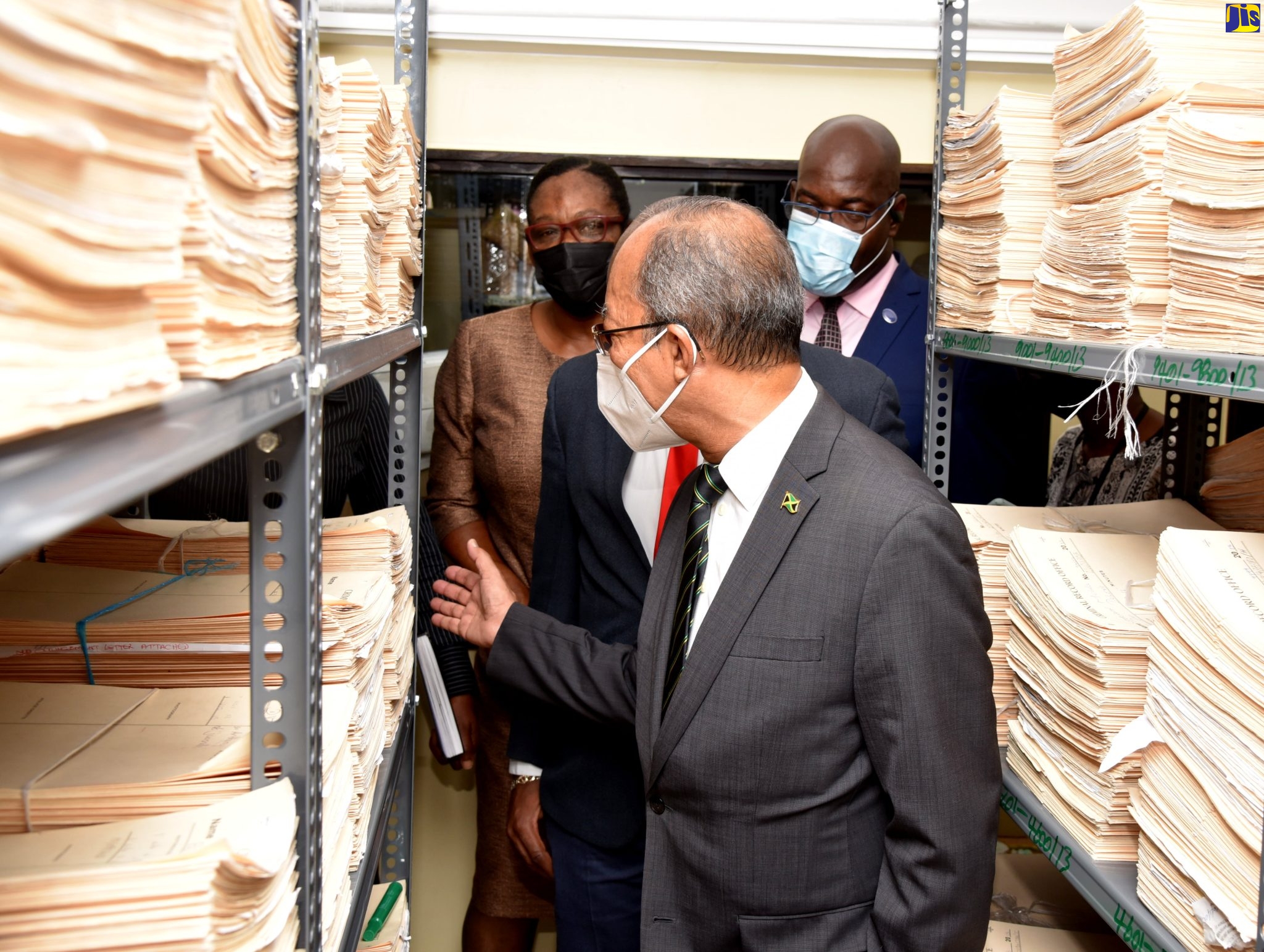 Minister of National Security, Hon Dr. Horace Chang (front), tours the docket room of the Jamaica Constabulary Force’s Criminal Records Office during his visit Thursday (June 9). Standing directly behind him is Head of the JCF Technology Branch, Assistant Commissioner of Police, Leonardo Brown, as well as (from left) Commanding Officer of JCF Technical Service Division, Donna Harris-Jones and Deputy Commissioner of Police, Fitz Bailey.