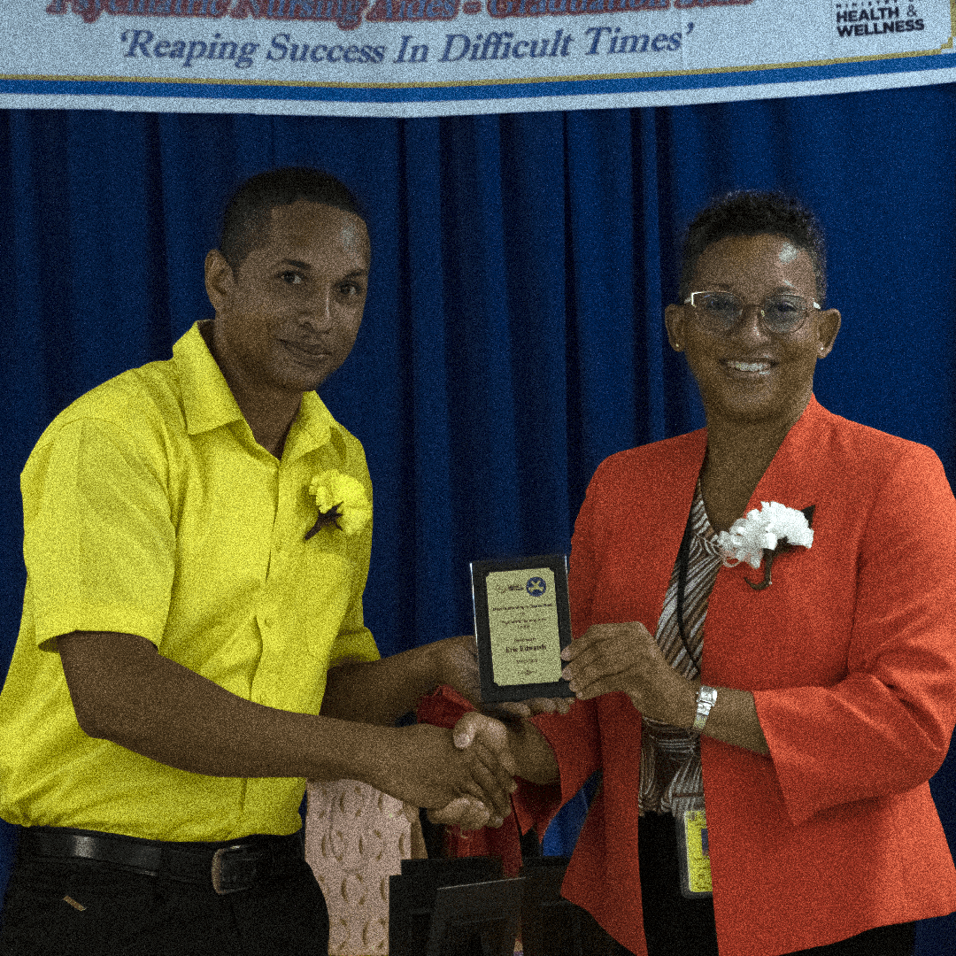 Correctional Officer Eric Edwards (left), assigned to the Rio Cobre Juvenile Correctional Centre in St. Catherine,  receives an award from Director of the Department of Correctional Services (DCS) Medical Services Unit, Dr. Donna-Michelle Royer-Powe for the most outstanding performance in the Psychiatric Nursing Aid Course, during a recent graduation exercise held at the DCS Lockett Avenue facility in Kingston.
