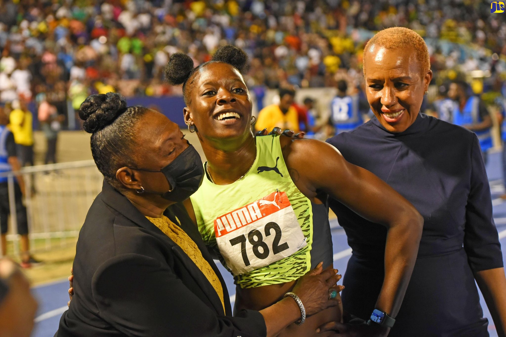 Minister of Culture, Gender, Entertainment and Sport, Hon. Olivia Grange (left), and Minister of Education and Youth, Hon. Fayval Williams (right), congratulate Olympian, Shericka Jackson, following her victory in the Women’s 100-metres final during the 2022 National Senior and Junior Athletics Championships at the National Stadium, on Friday (June 24).