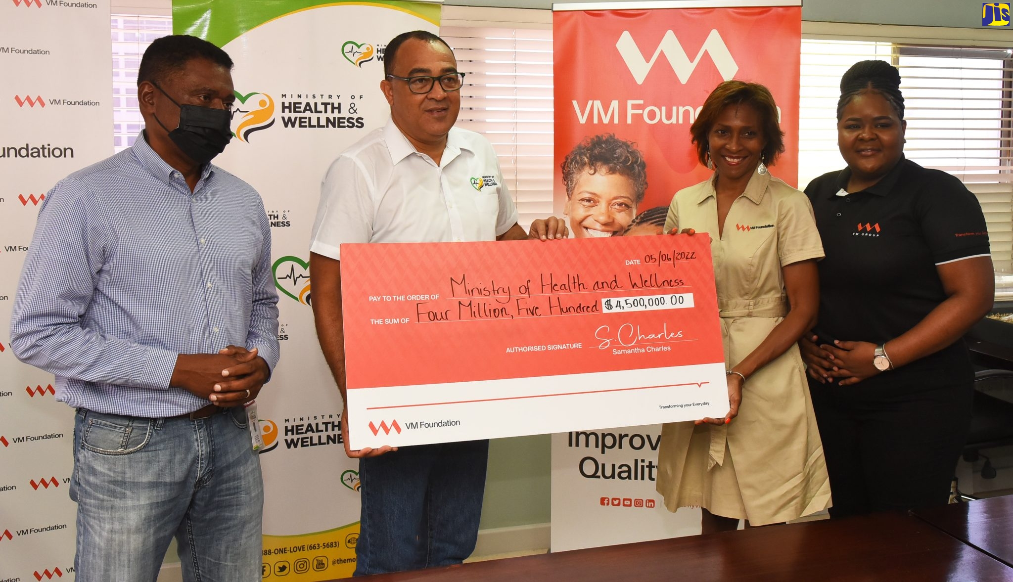 Minister of Health and Wellness, Dr. the Hon. Christopher Tufton (second left), accepts a symbolic cheque valued at $4.5 million from Chief Executive Officer, Victoria Mutual (VM) Foundation, Samantha Charles (second right), following the contract signing with VM Foundation for the three-year renewal agreement for the adoption of the St. Jago Health Centre, St. Catherine,  under the Ministry’s Adopt-A-Clinic Programme. The ceremony was held at the Ministry’s New Kingston offices recently. Sharing in the moment (from left) are Executive Director, Philanthropic Mobilisation, Ministry of Health and Wellness, Courtney Cephas, and Financial Services Specialist, Victoria Mutual, Shamalla McGregor.